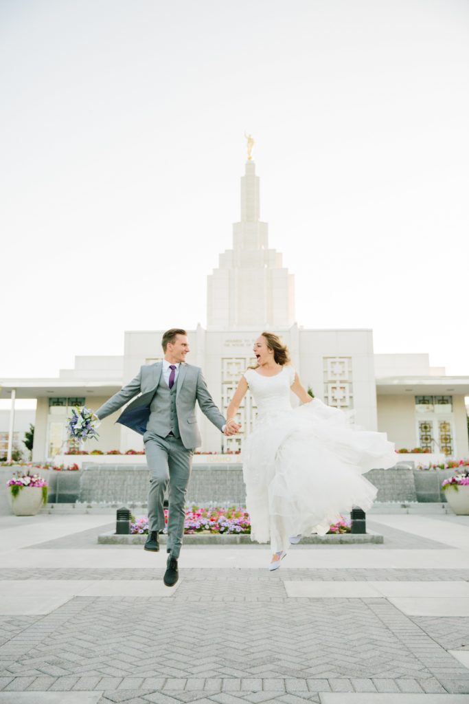 Jackson Hole wedding photographer capturesbride and groom jumping for joy