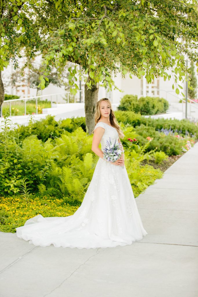 Jackson Hole wedding photographer captures Bride posed with flowers