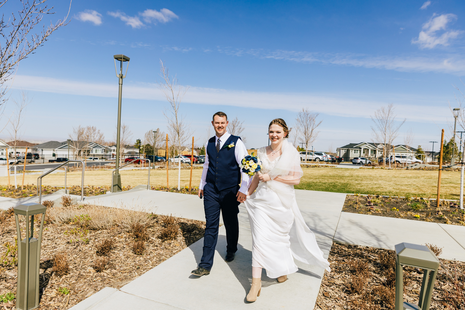 Jackson Hole wedding photographer captures Bride and groom walking off pocatello temple grounds