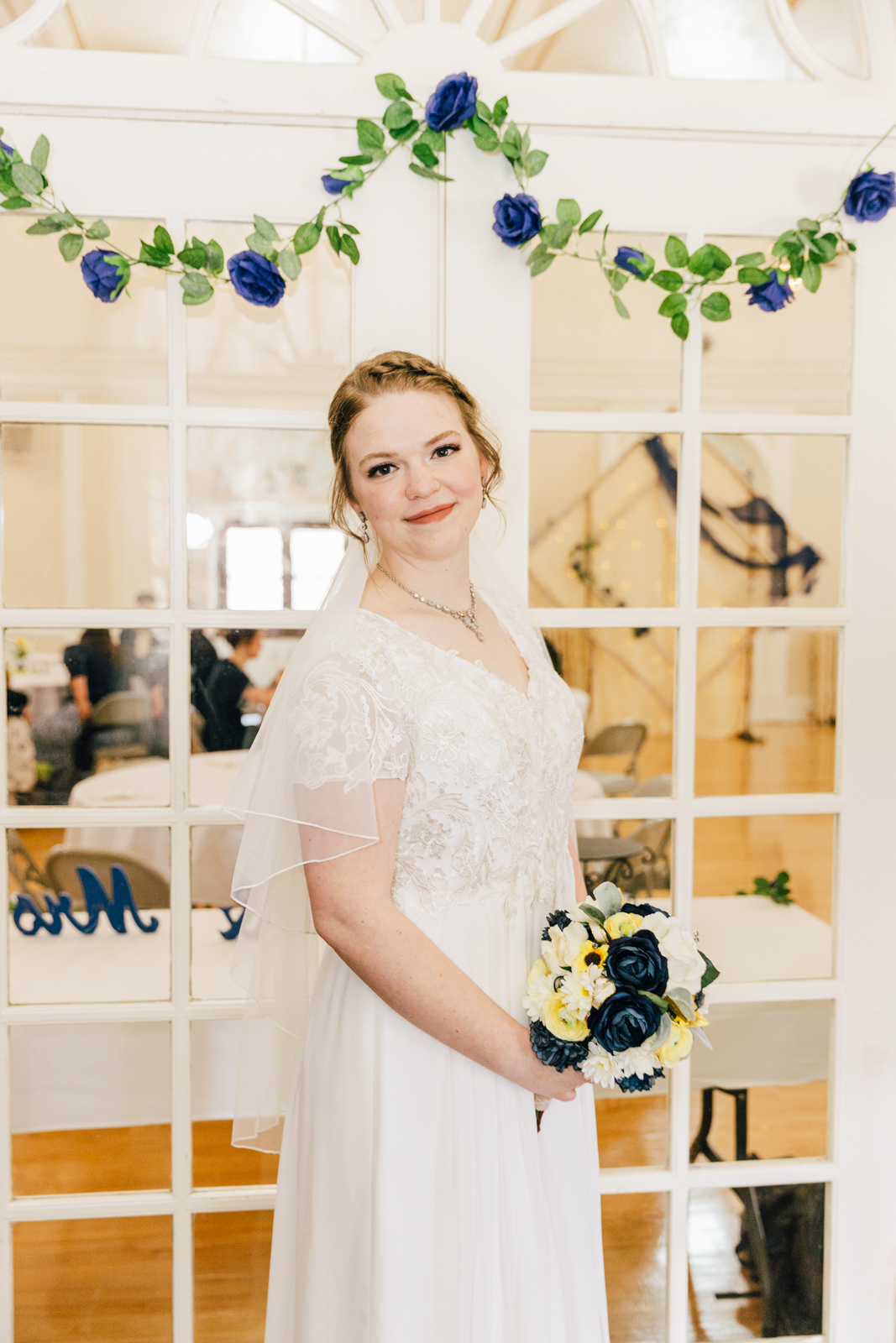 Jackson Hole wedding photographers capture bride standing by venue windows