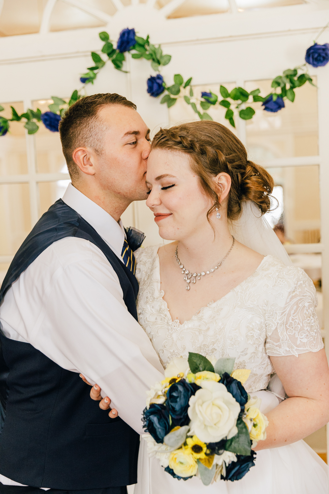 Jackson Hole wedding photographers capture groom kissing head of bride