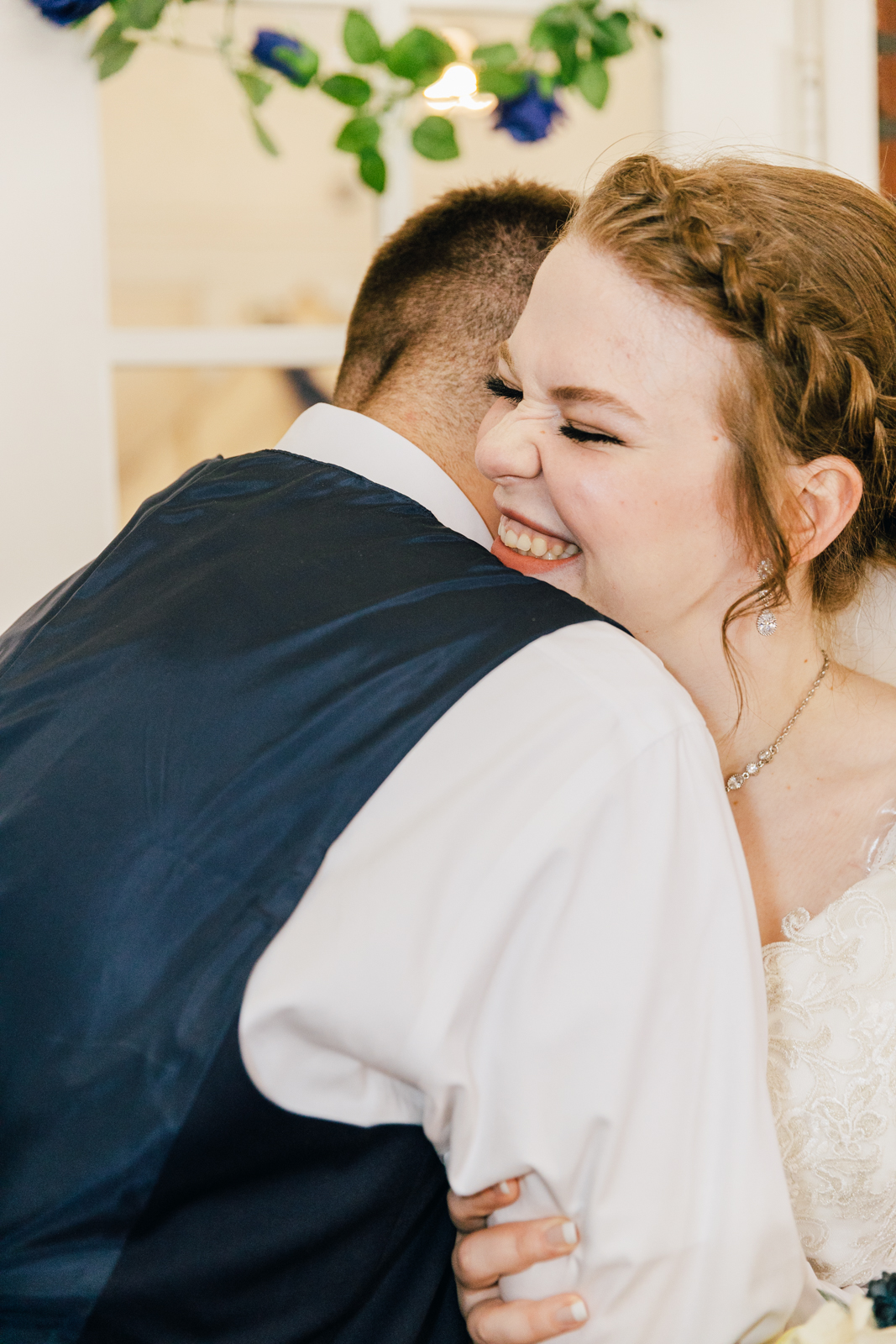 Jackson Hole wedding photographers capture bride laughing into grooms shoulder