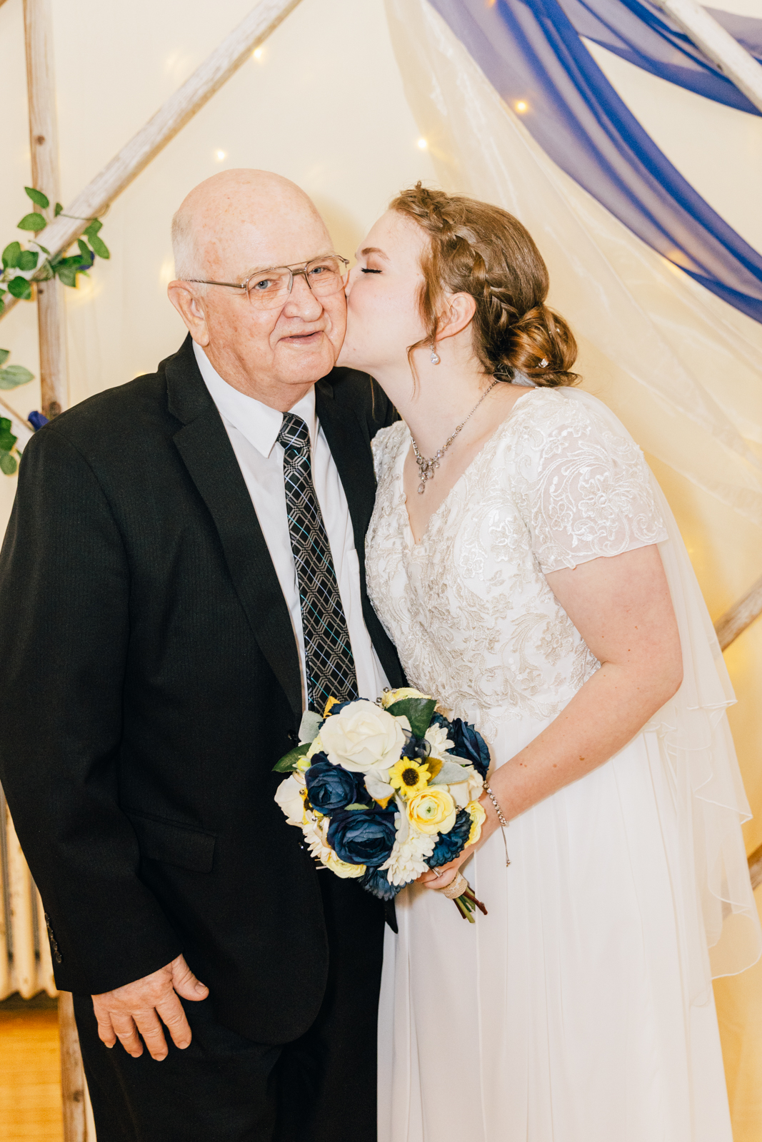 Jackson Hole wedding photographer capturesbride kissing grandpa