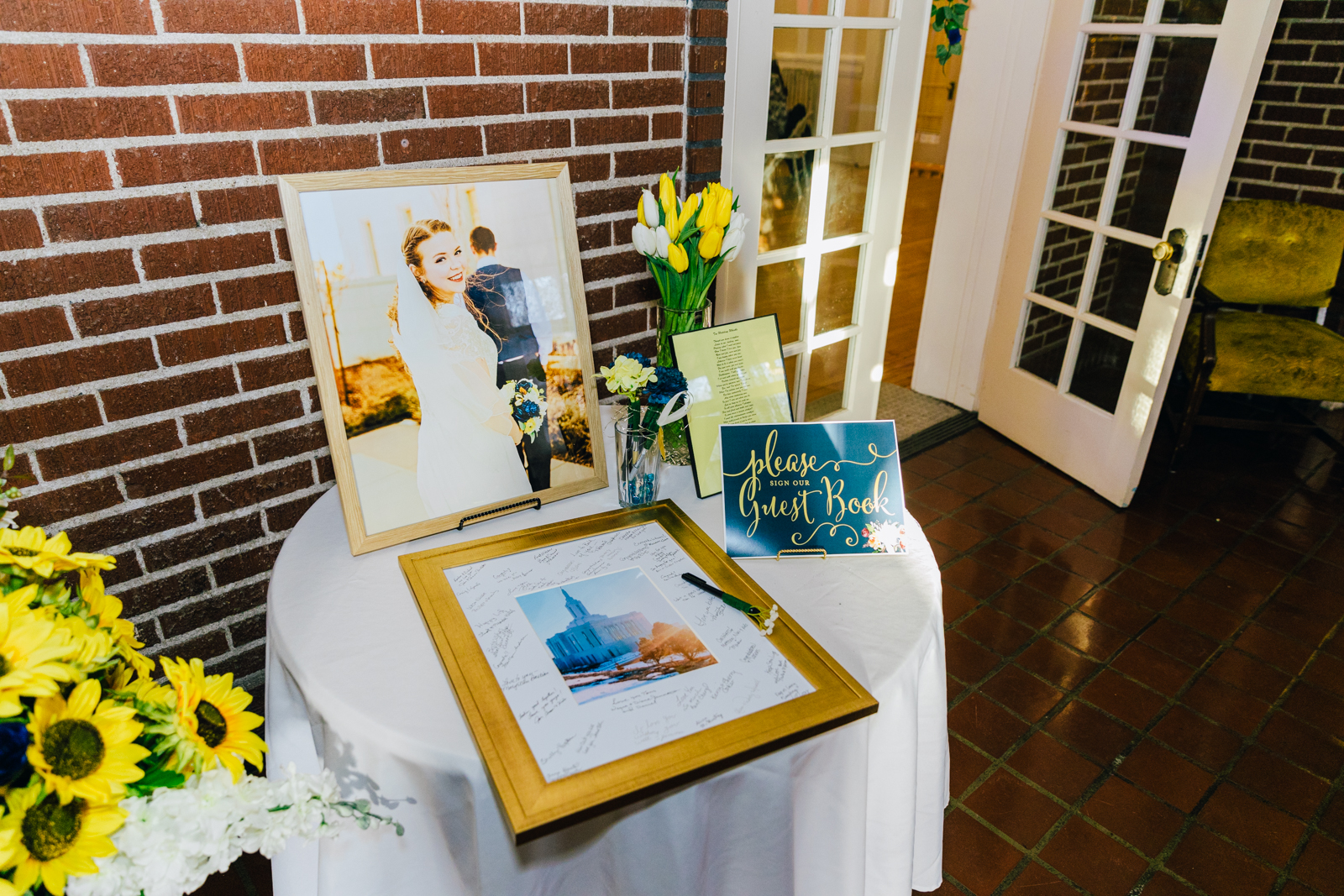 Jackson Hole wedding photographer captures entrance table with pictures and sign in book