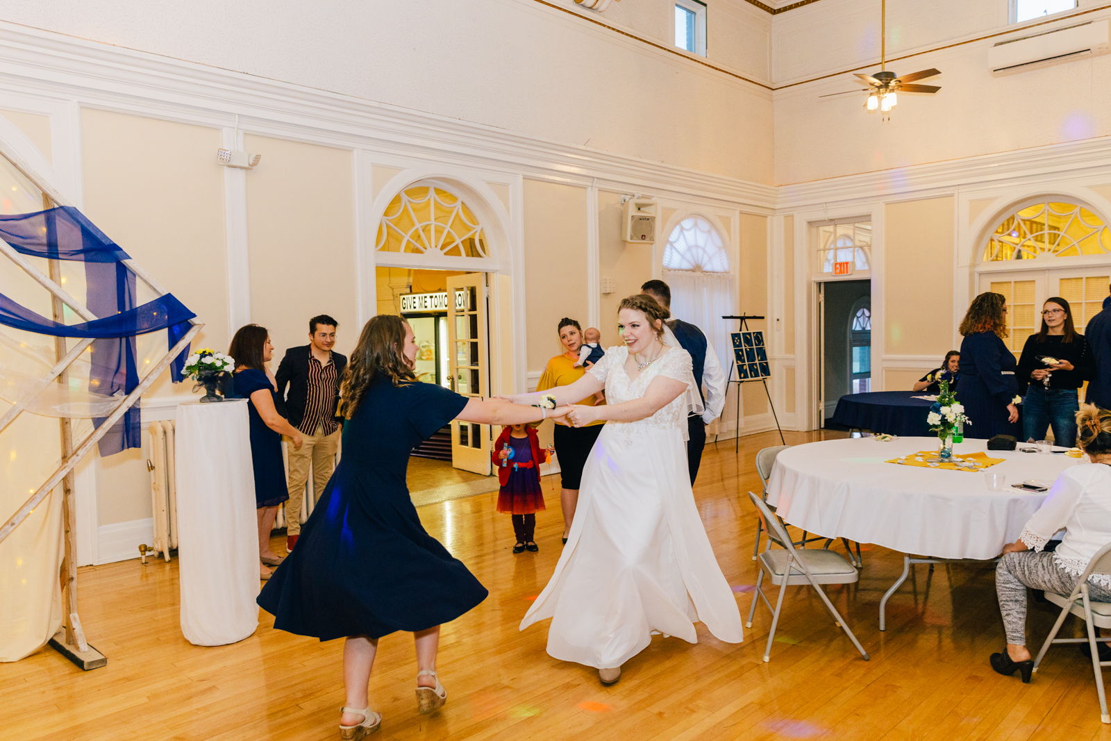 Jackson Hole wedding photographer captures bride dancing with sister at ballroom