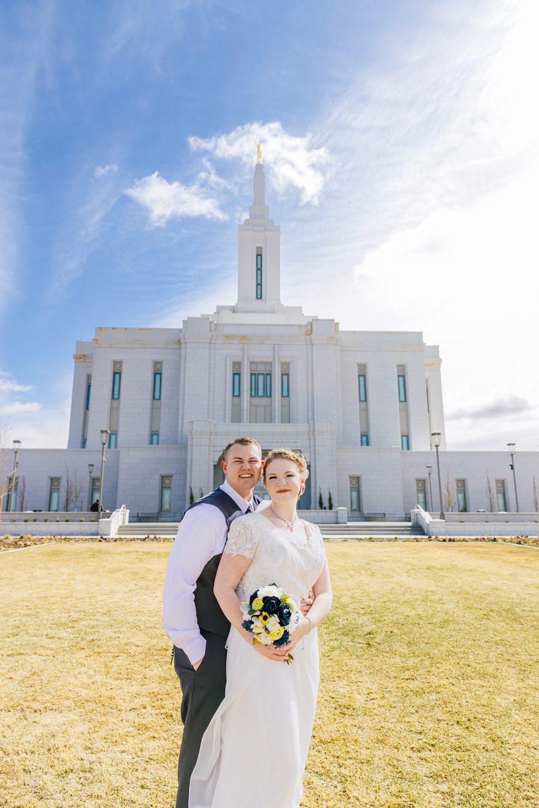 Jackson Hole wedding photographer captures bridal couple in front of temple 