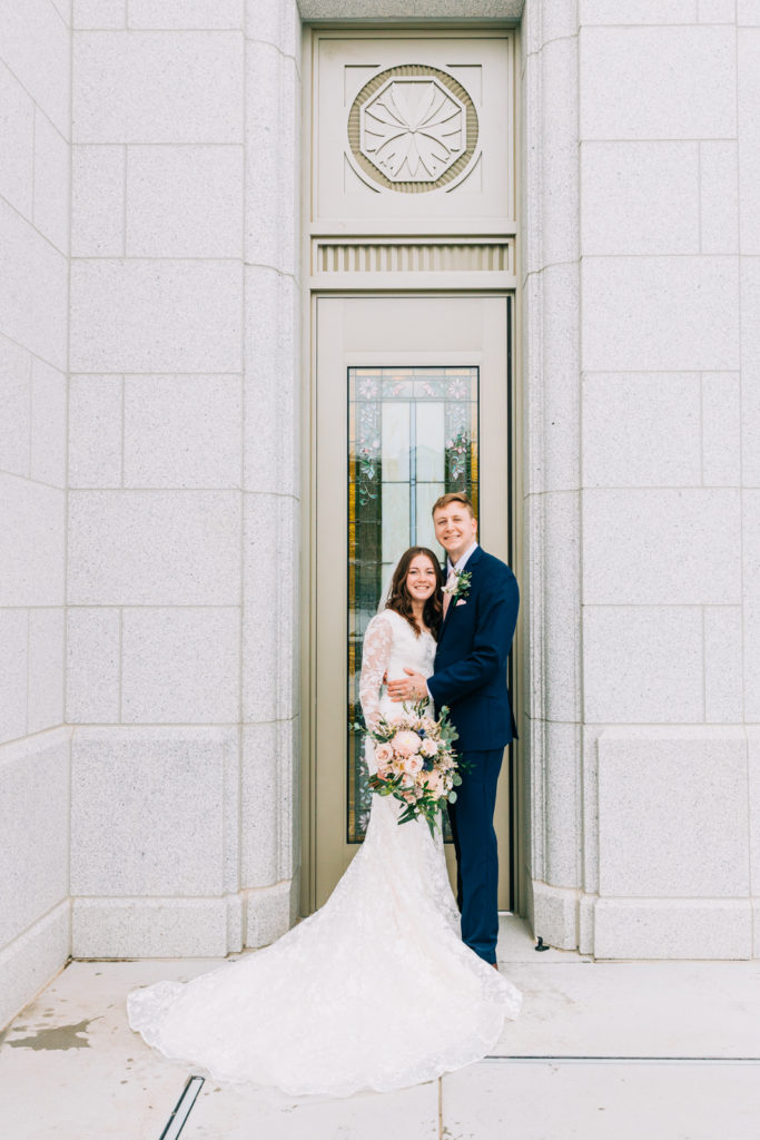 Jackson Hole wedding photographer captures Bride and groom outside of pocatello temple door