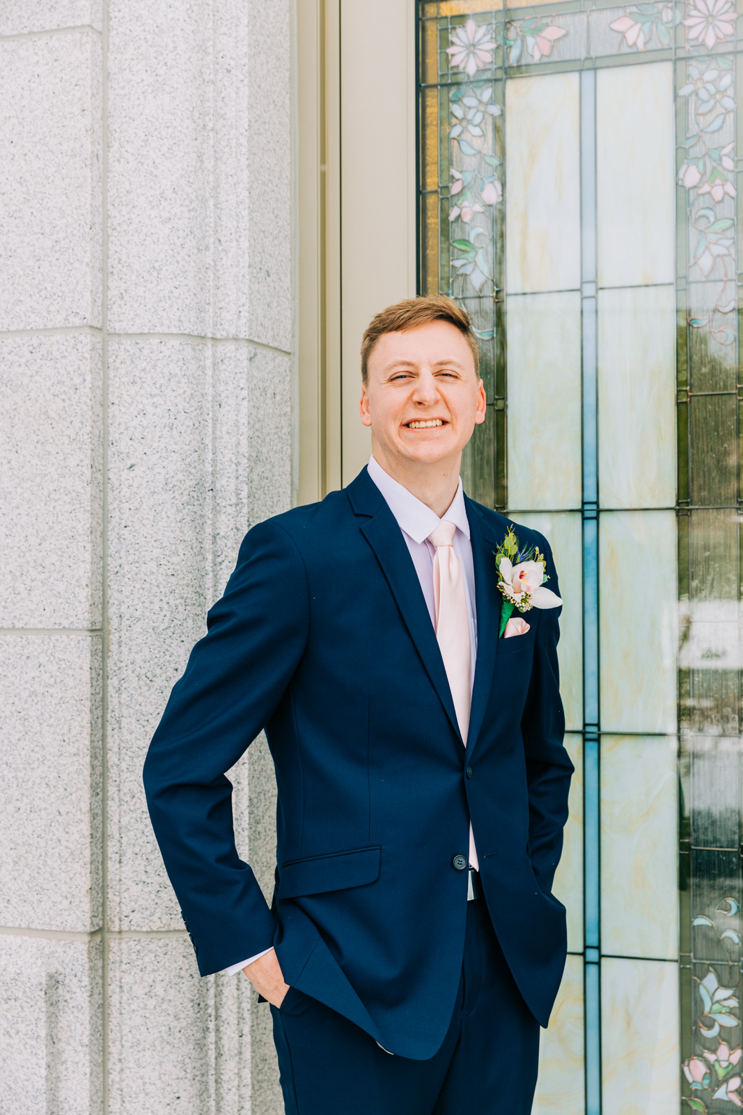 Jackson Hole wedding photographer captures groom smiling and wearing navy