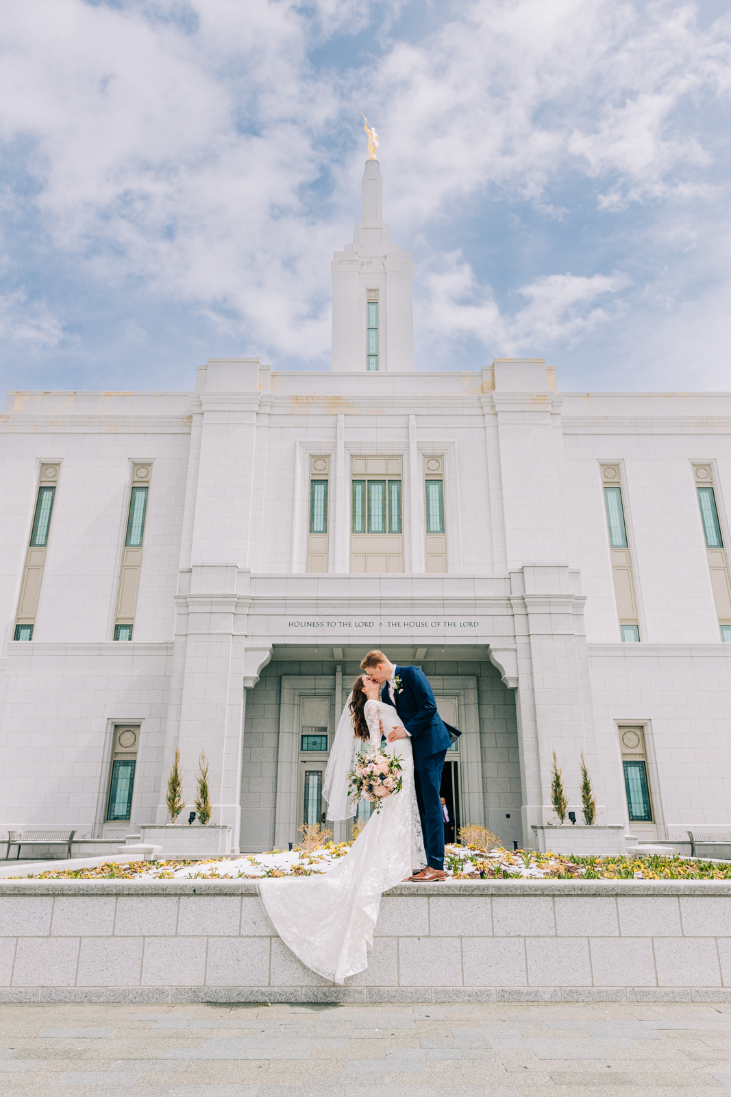 Jackson Hole wedding photographer captures couple kissing in front of LDS Temple