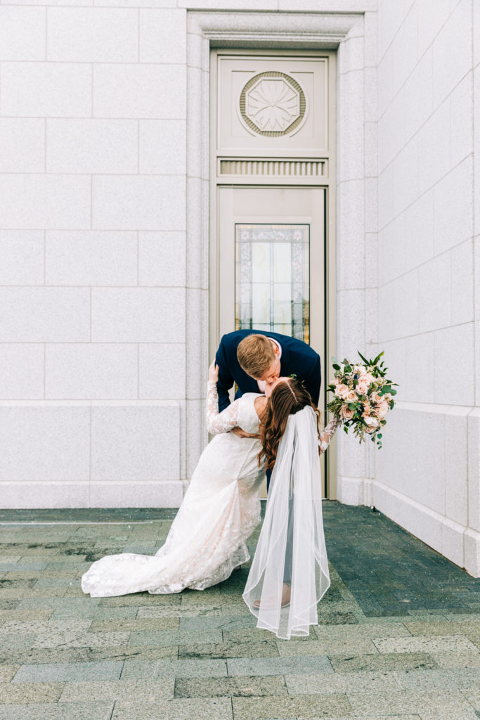 Jackson Hole wedding photographer captures dip and kiss outside of lds temple pocatello
