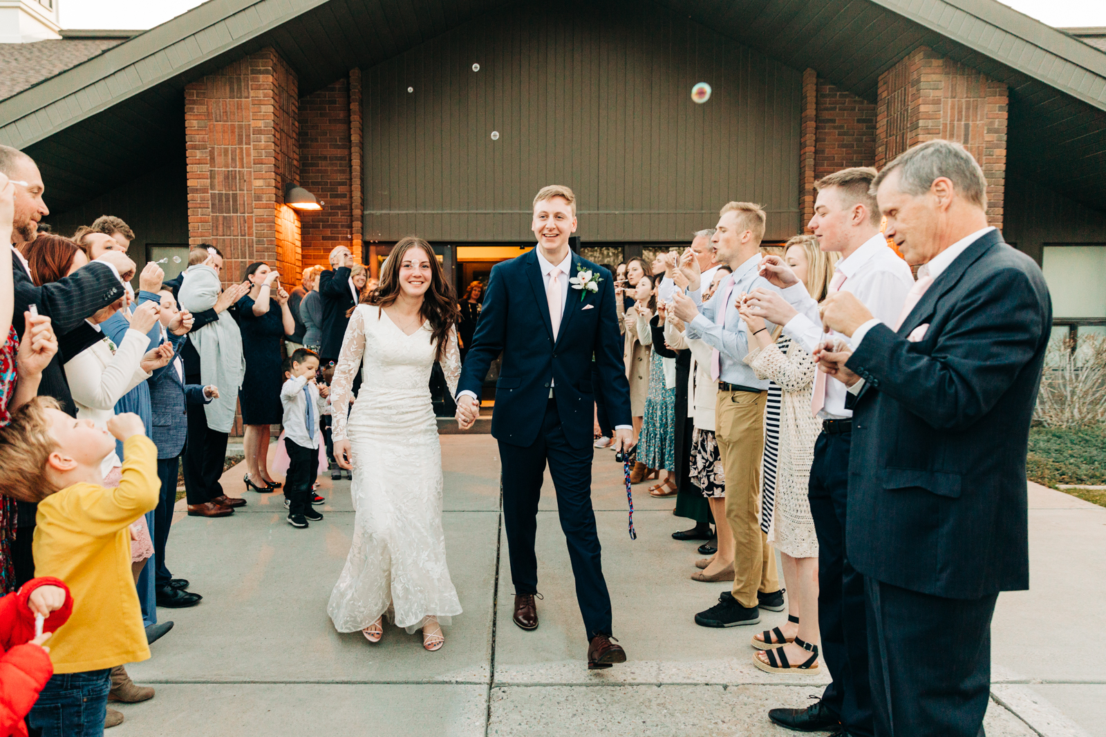 Jackson Hole wedding photographer captures bride and groom leaving reception