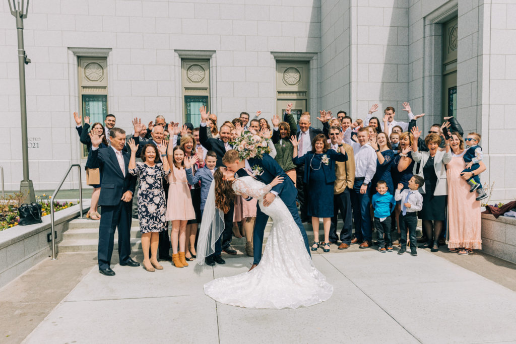 Jackson Hole wedding photographer captures groom dipping bride at pocatello idaho temple