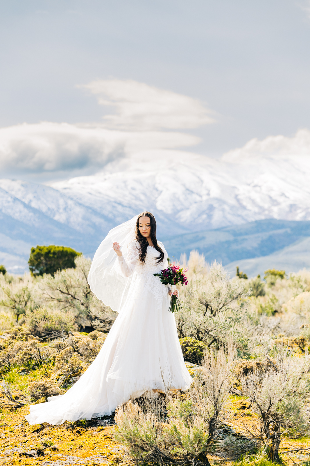 Jackson Hole wedding photographer captures wind picking up brides veil in pocatello mountains