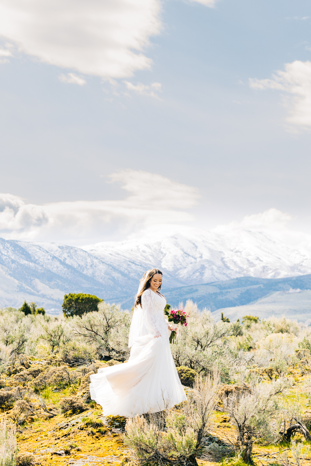 Jackson Hole wedding photographer captures bride moving dress around in wind