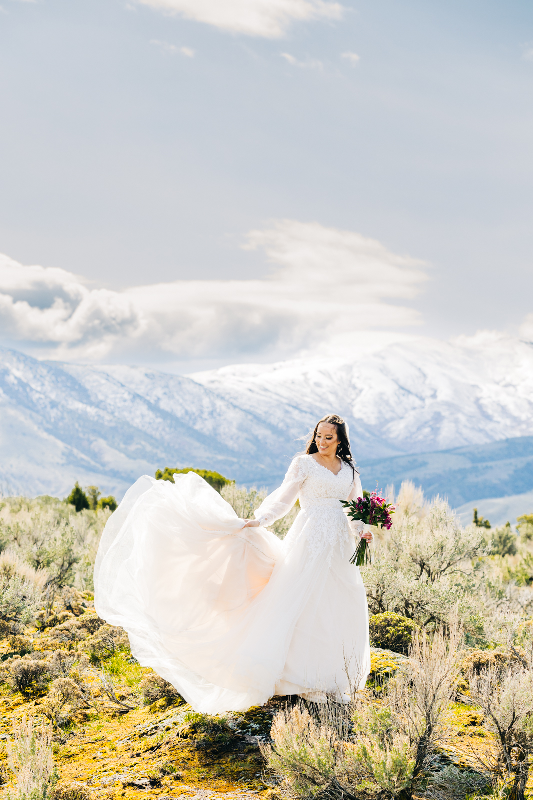 Jackson Hole wedding photographer capturesjackson hole bride in mountains with dress