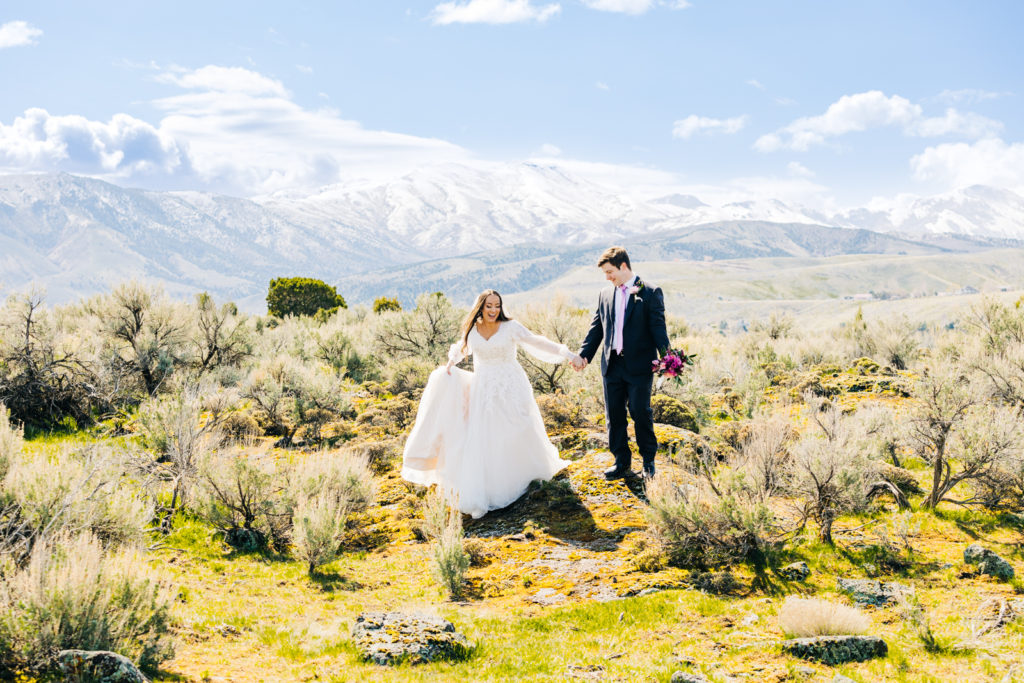 Jackson Hole wedding photographer captures Ethereal Pocatello Bridal session bride and groom walking off lava rock into green grassy area