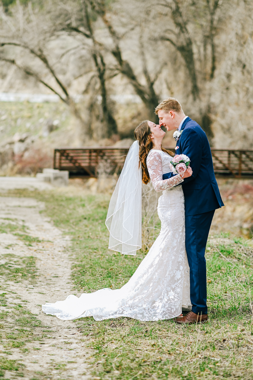 bride and groom huggin for their outdoor bridal portraits on their Idaho wedding day