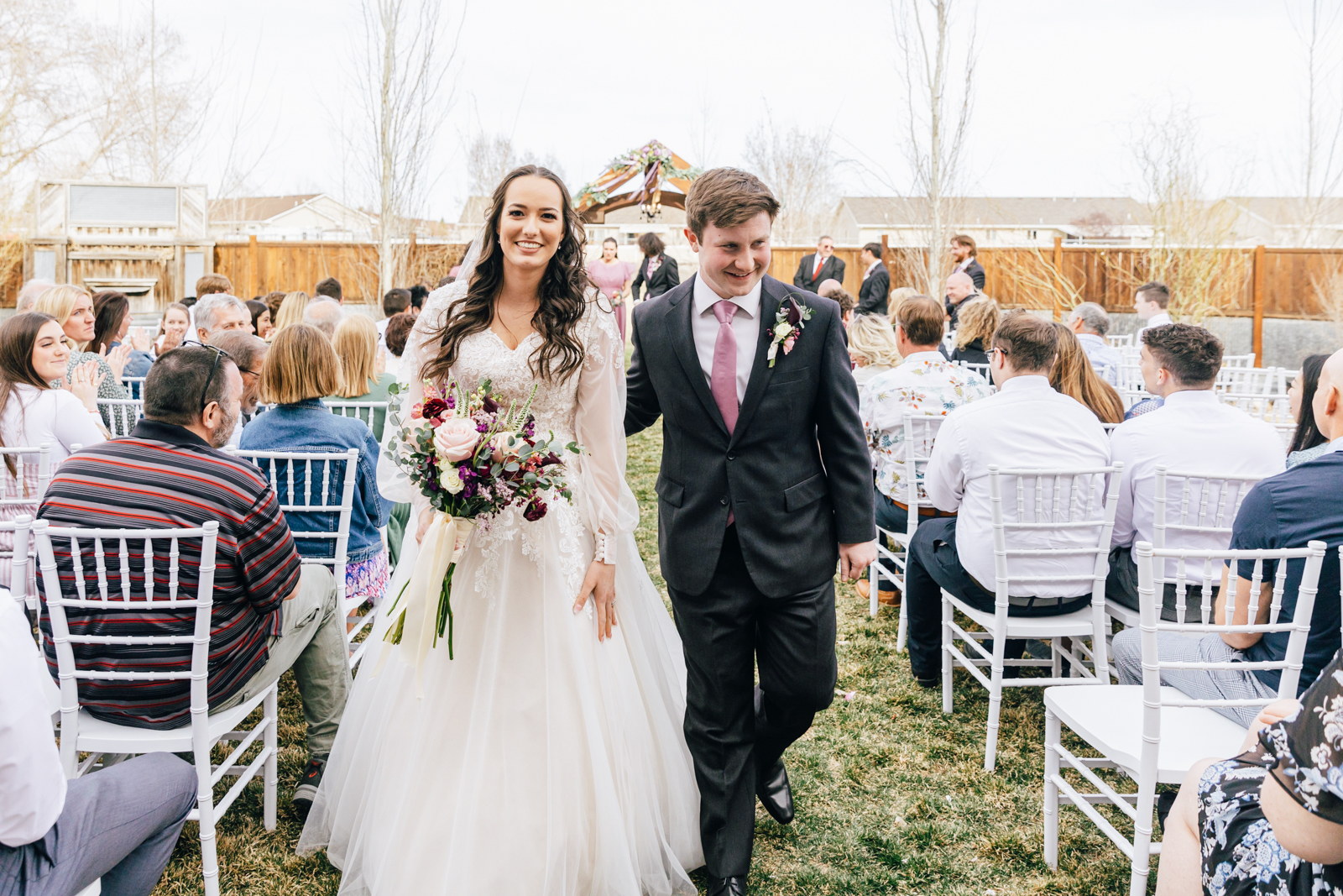 Jackson Hole wedding photographer captures bride and groom walking down aisle together
