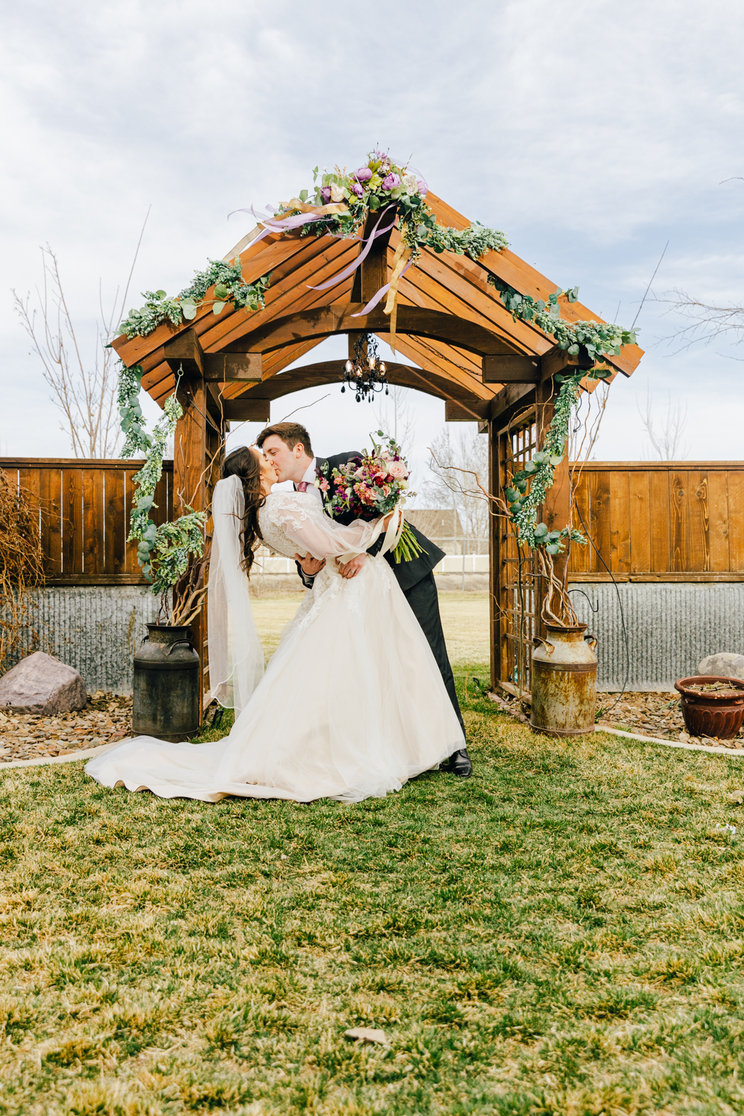 Jackson Hole wedding photographer captures bride and groom kissing as husband and wife