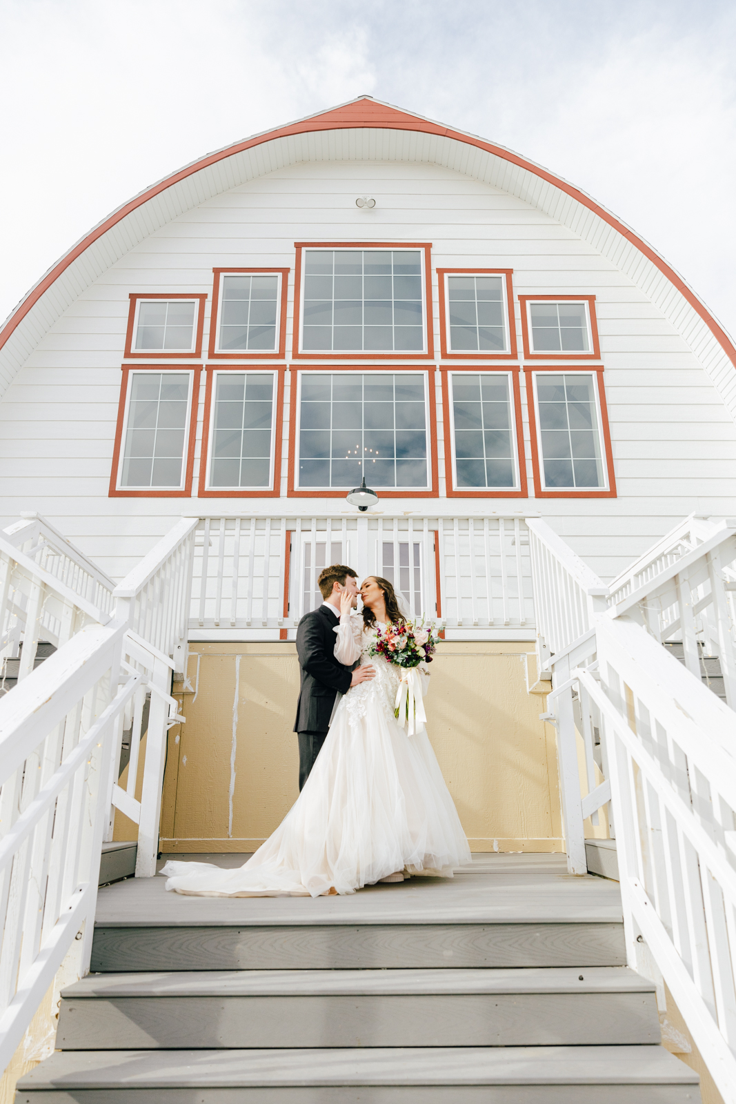 Jackson Hole wedding photographer captures bride and groom embracing at Barn on 1st