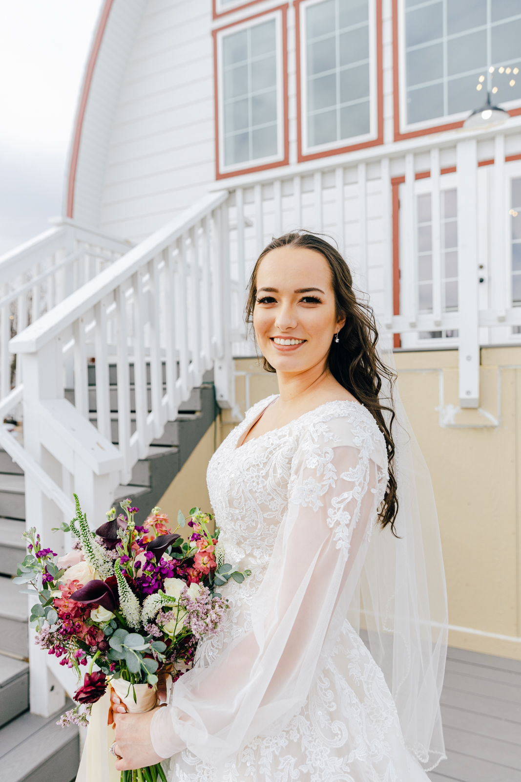 Jackson Hole wedding photographer captures bride outside barn wedding venue idaho falls
