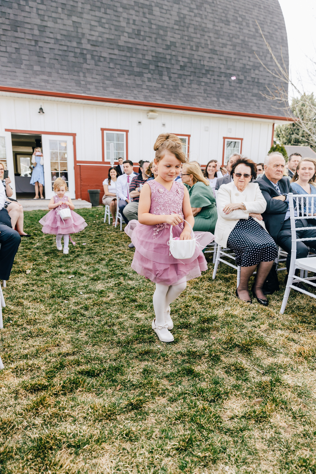 Jackson Hole wedding photographer capturesflower girl windy wedding