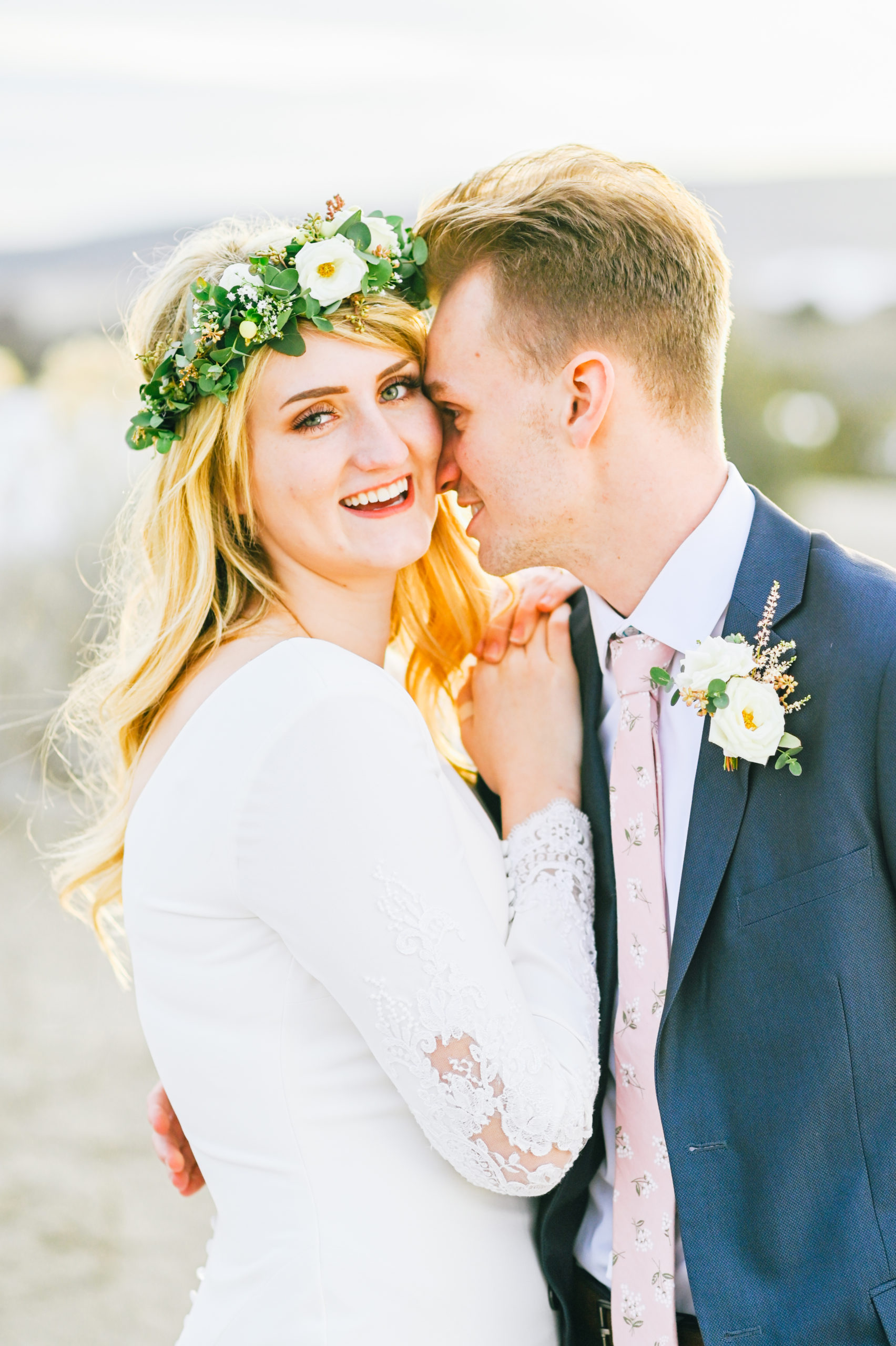 bride and groom embracing during outdoor bridal portraits