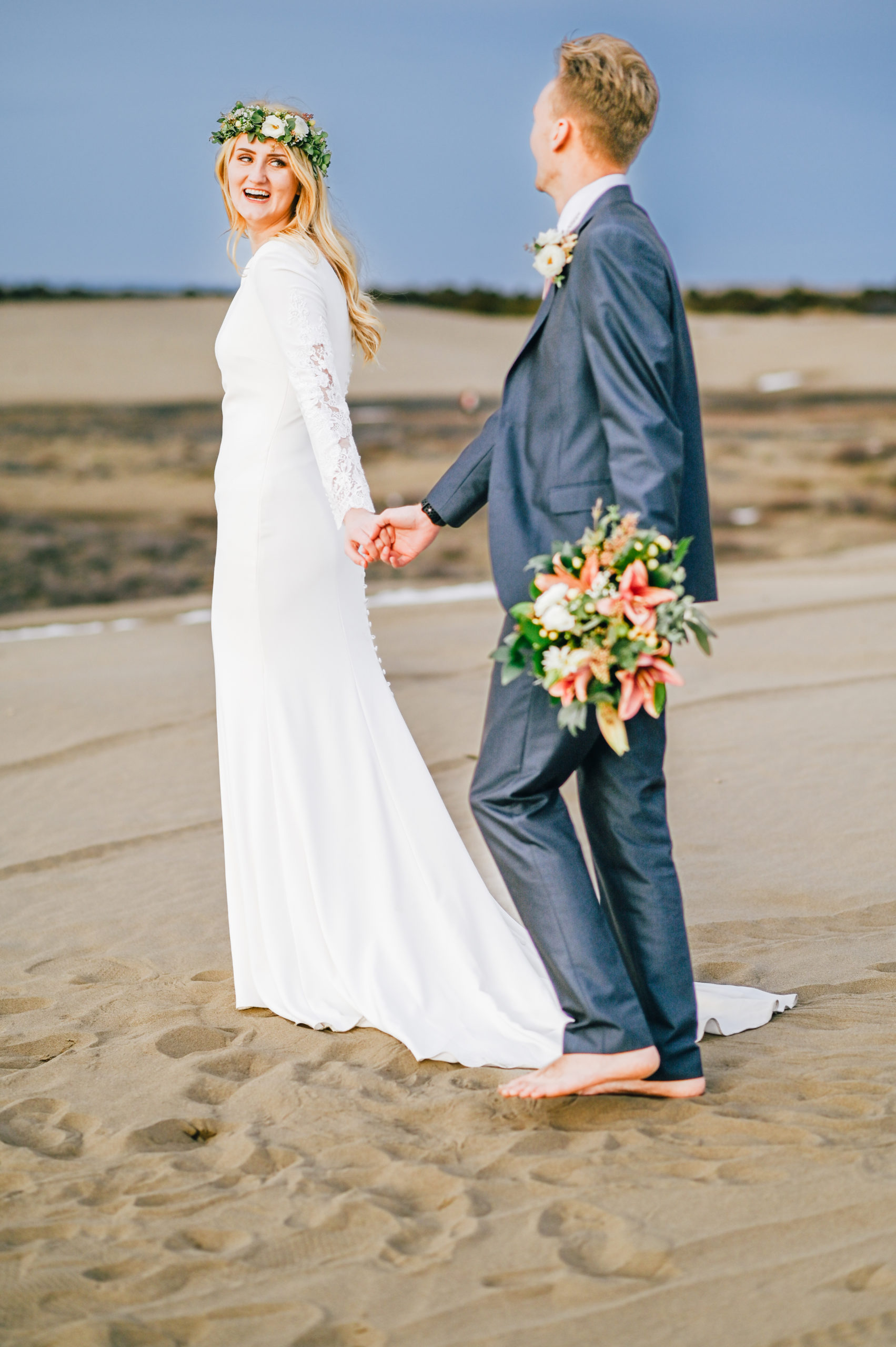 bride laughing at groom at sand dunes with no shoes at sand dunes