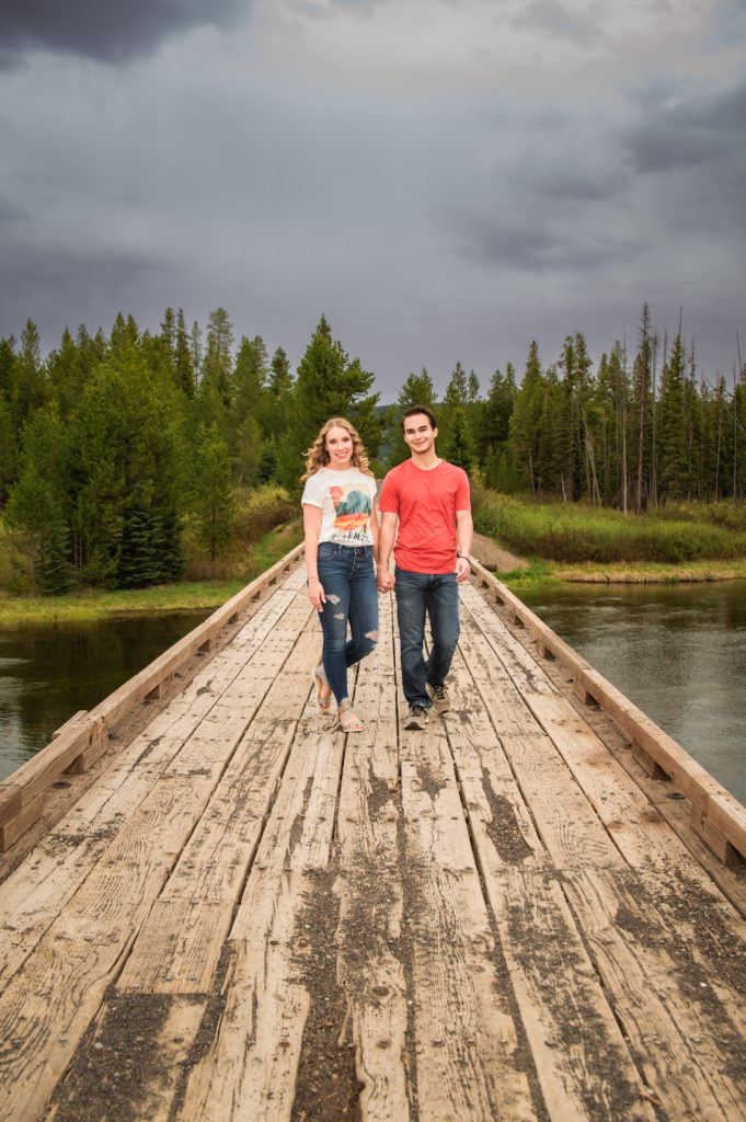 man and woman walking on bridge together