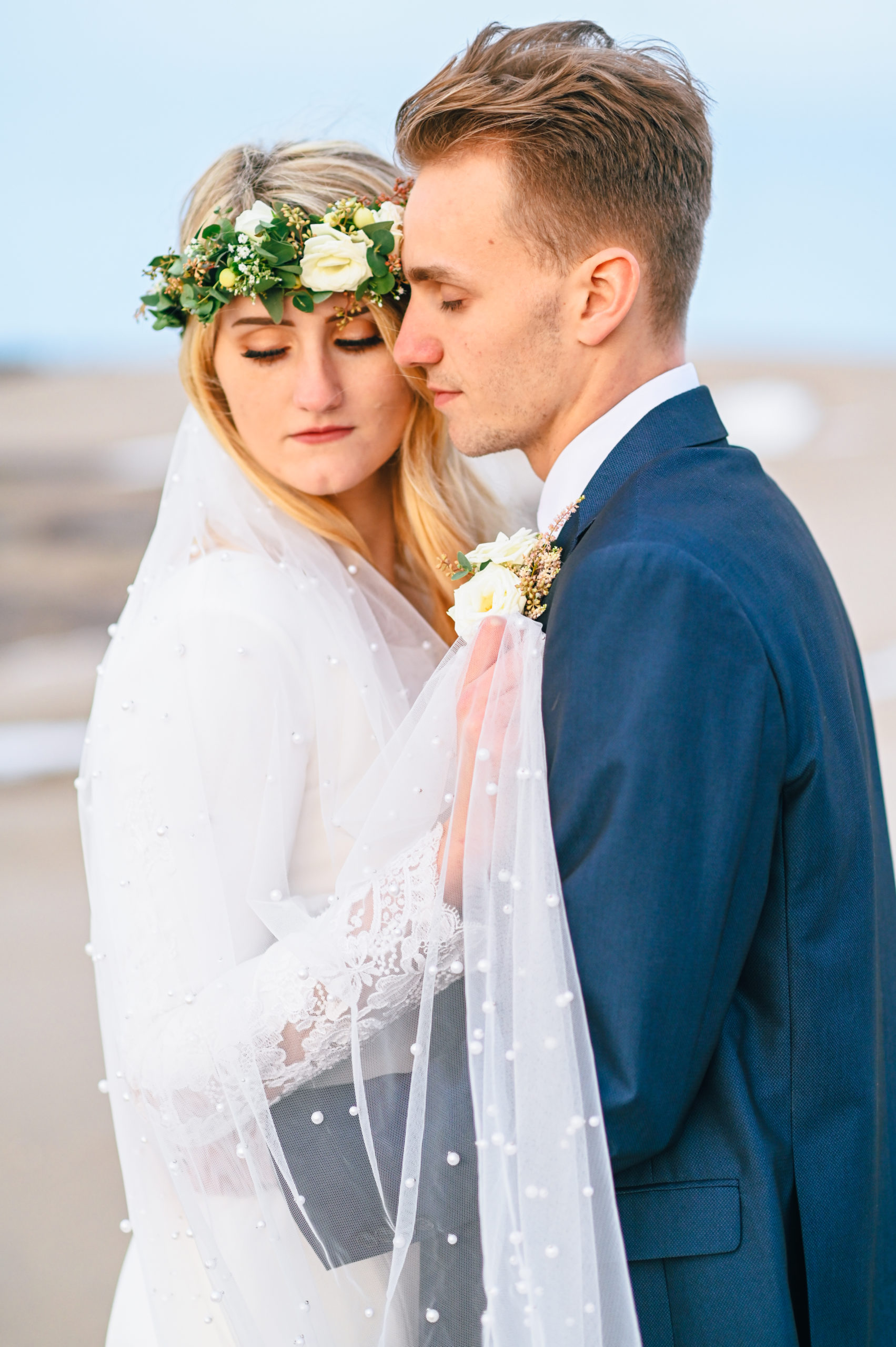 bride and groom embracing and looking away