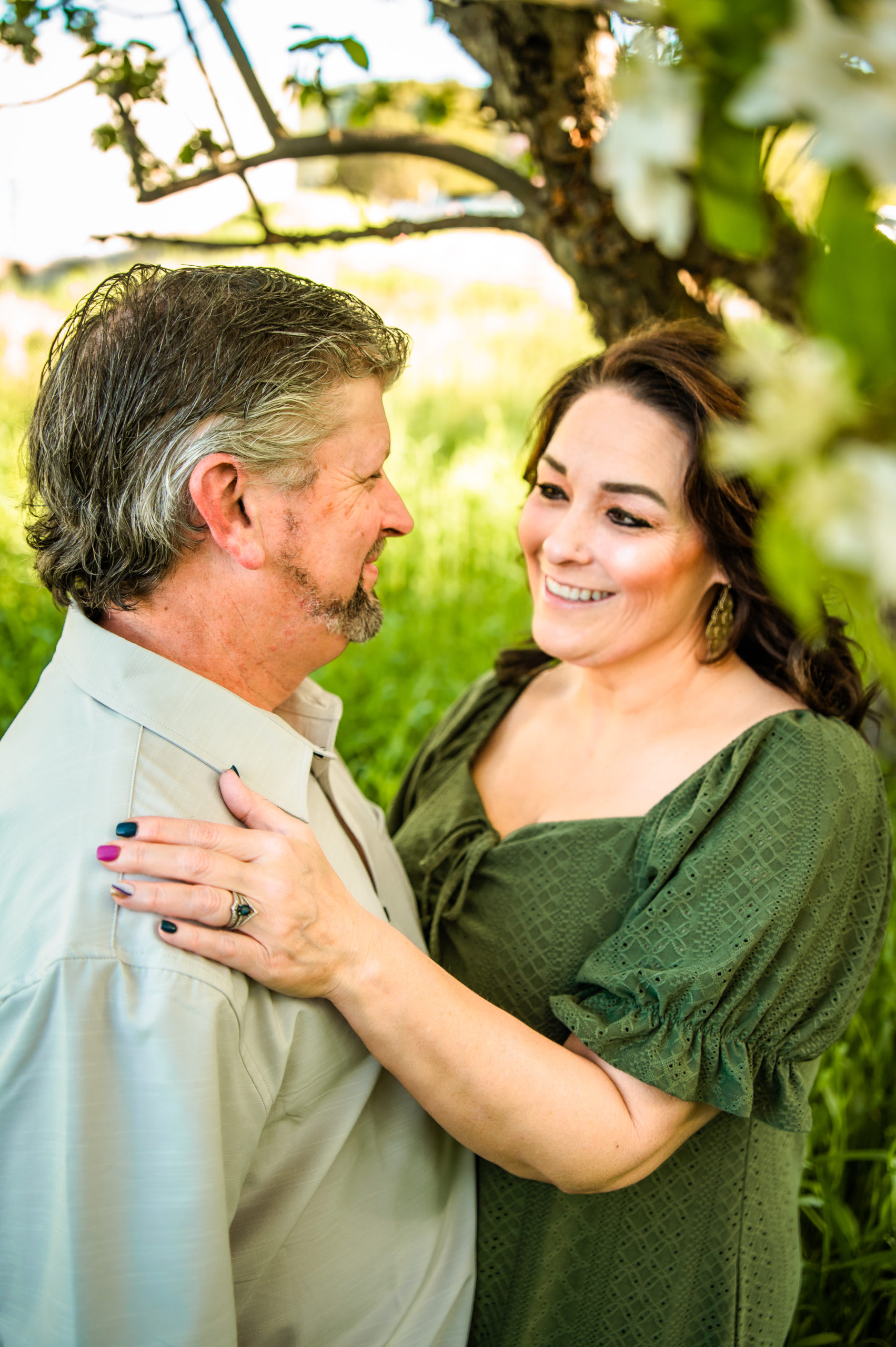 woman placing hand on man's shoulder and smiling during Western Sunset Engagements