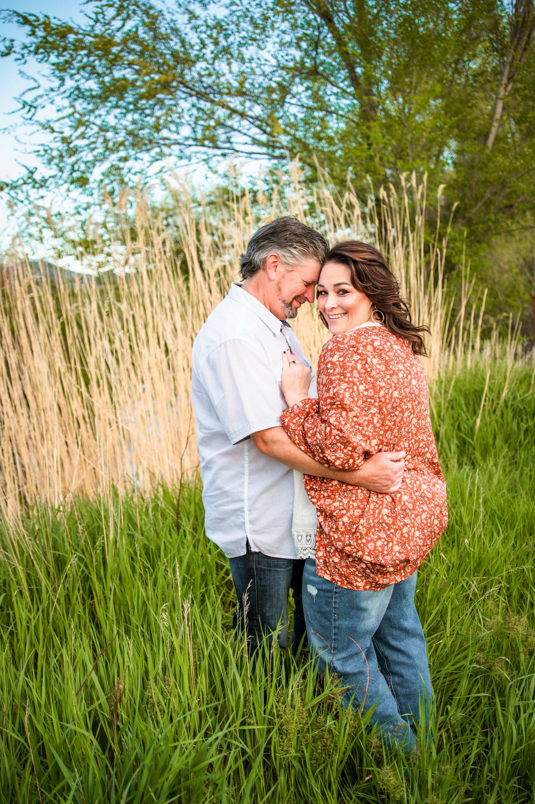 couple embracing and smiling during Western Sunset Engagements