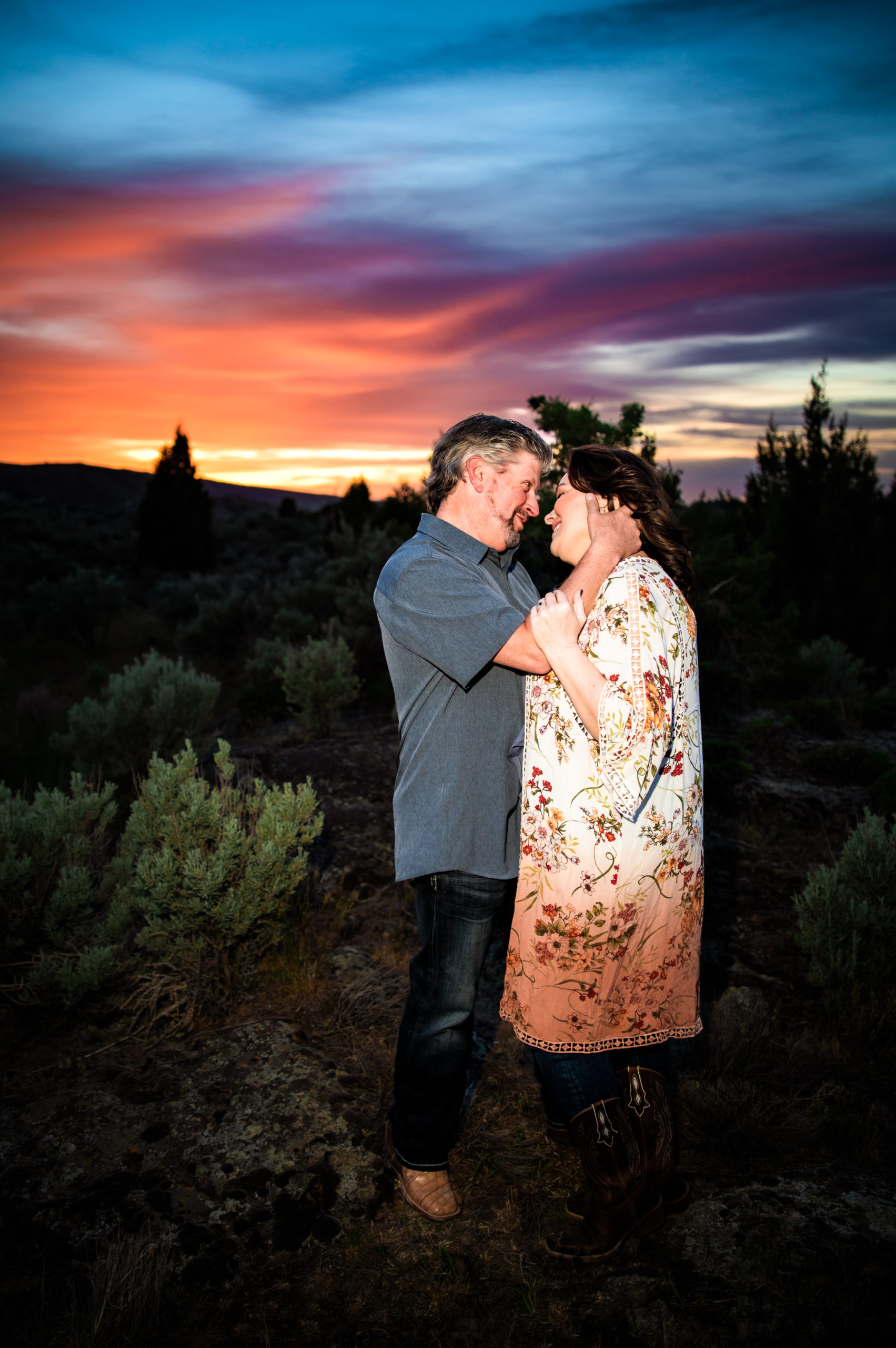 man smiling at woman during sunset engagement portraits