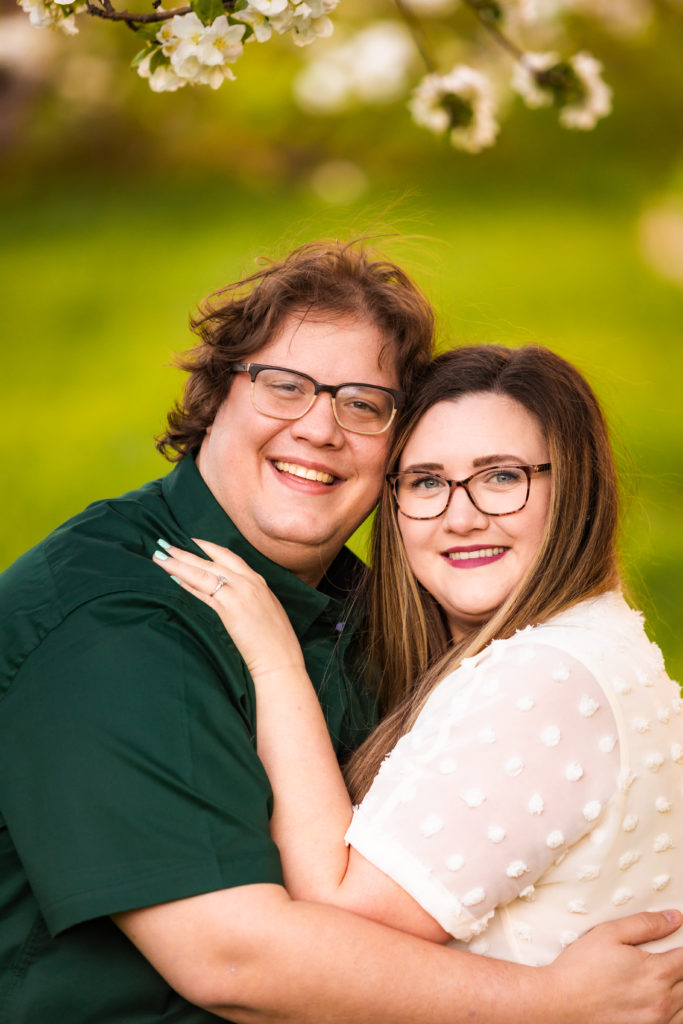 man and woman both wearing glasses embracing smiling during lively pocatello engagements