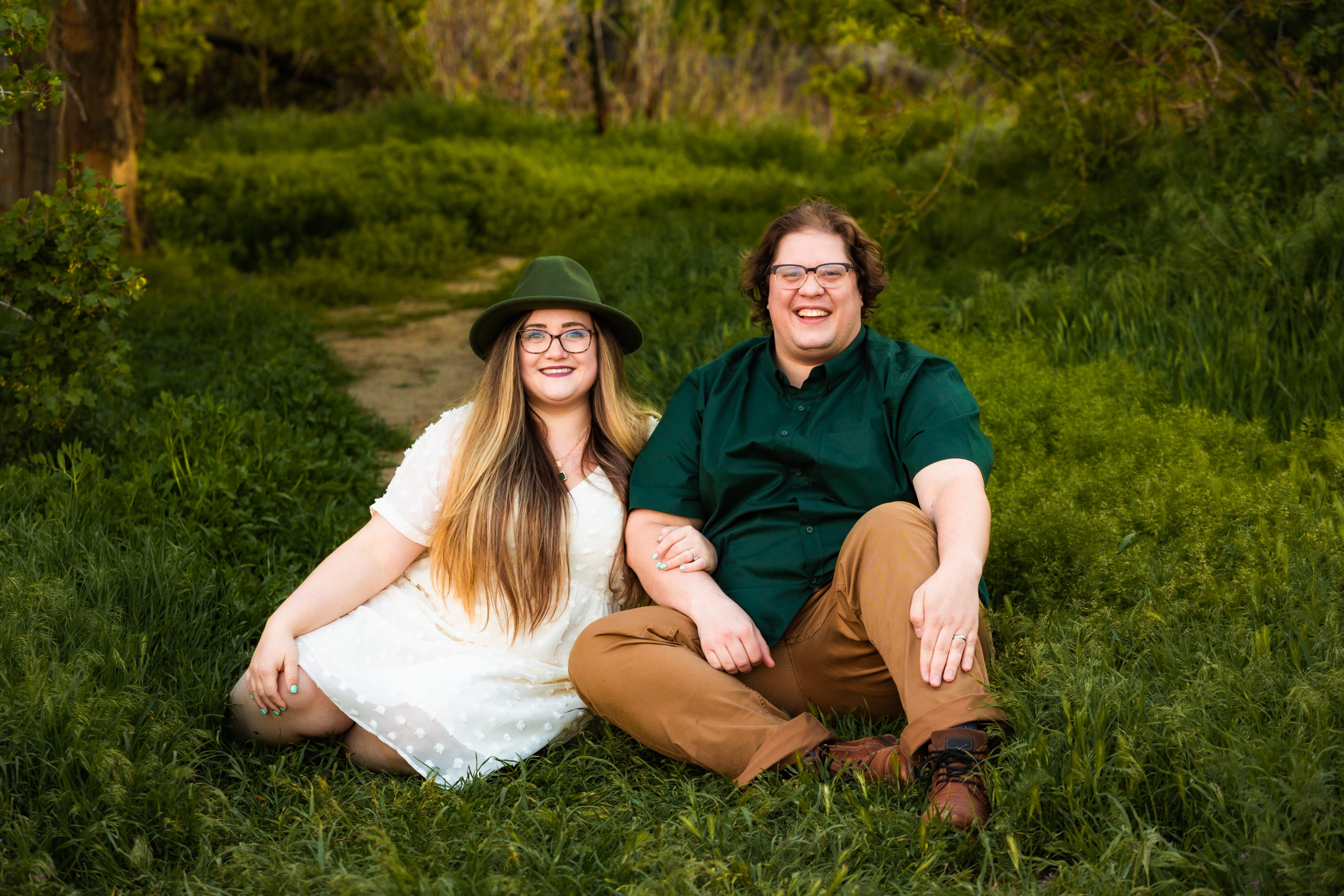 couple sitting on grass laughing together