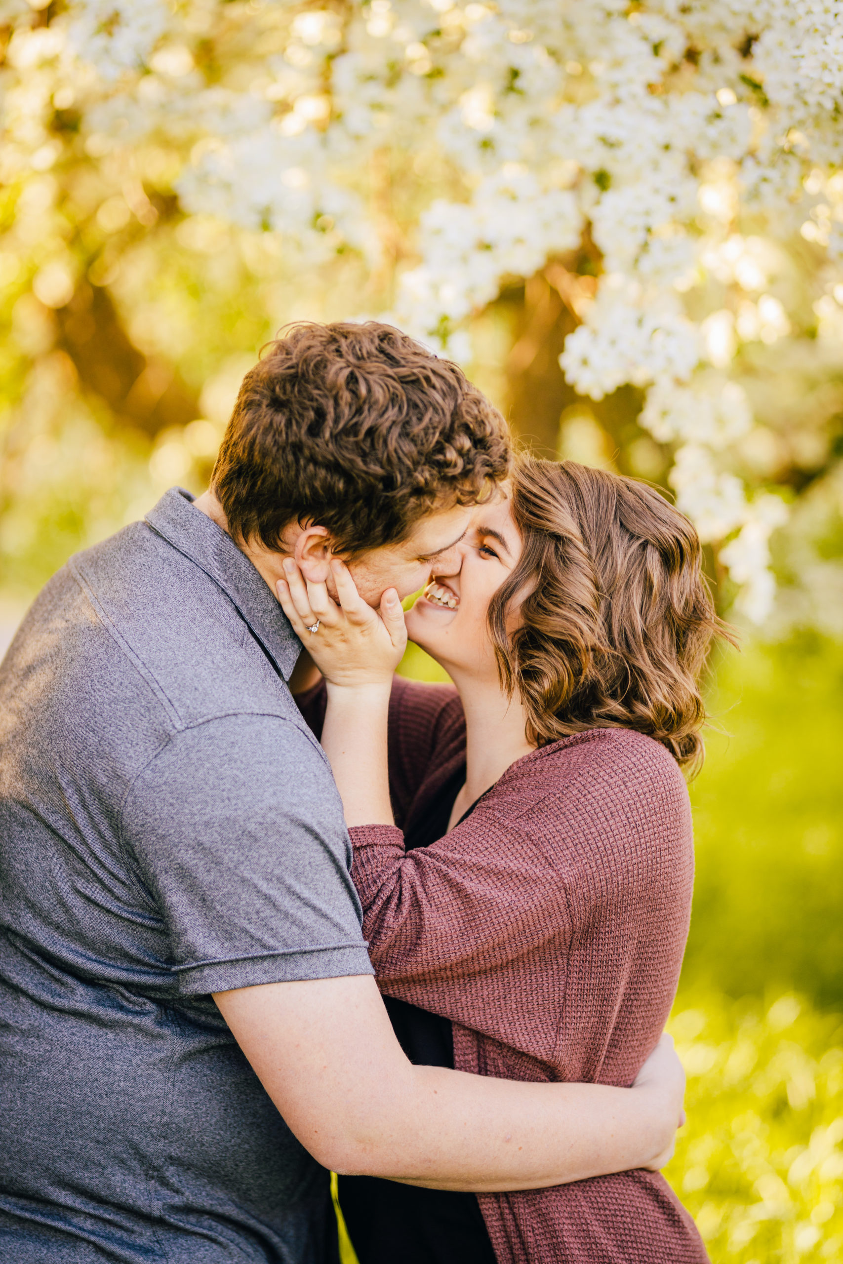 couple kissing and hugging during outdoor engagements