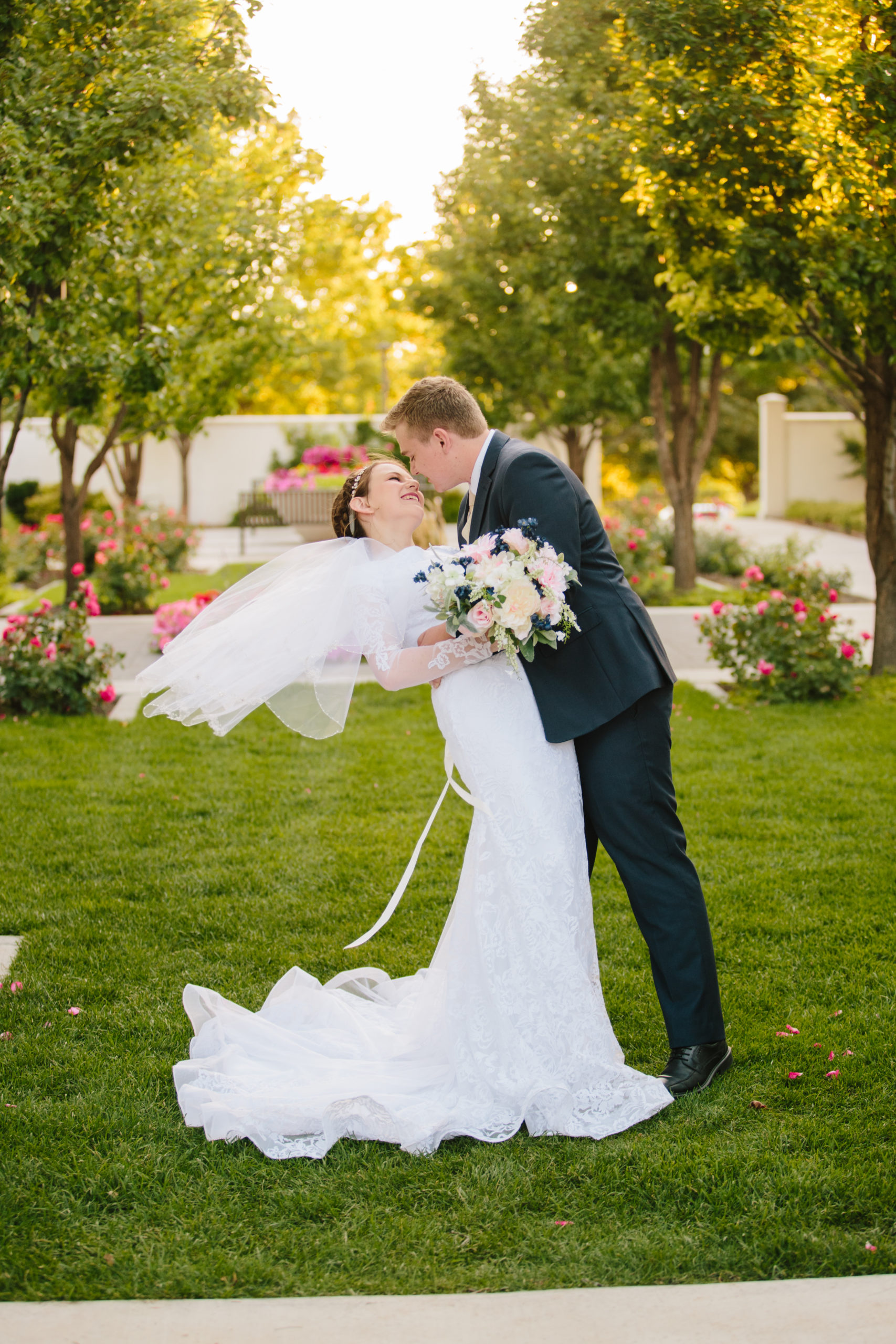 groom dipping bride with wind swept veil Idaho Falls Temple Wedding Tips