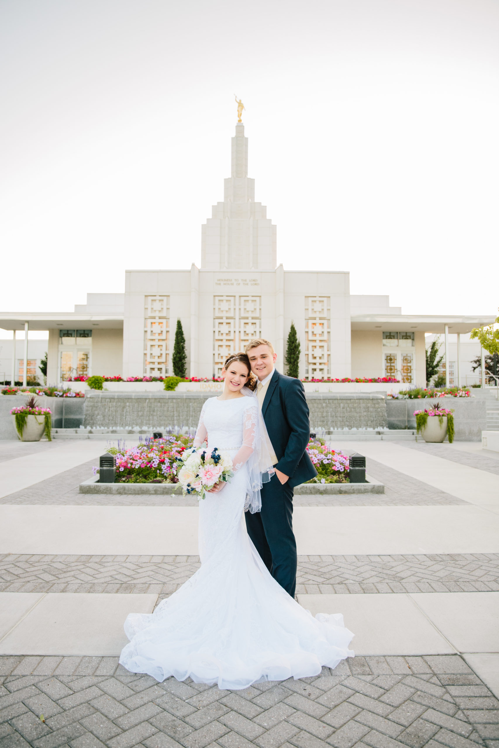 bride and groom looking at camera at idaho falls temple grounds Idaho Falls Temple Wedding Tips