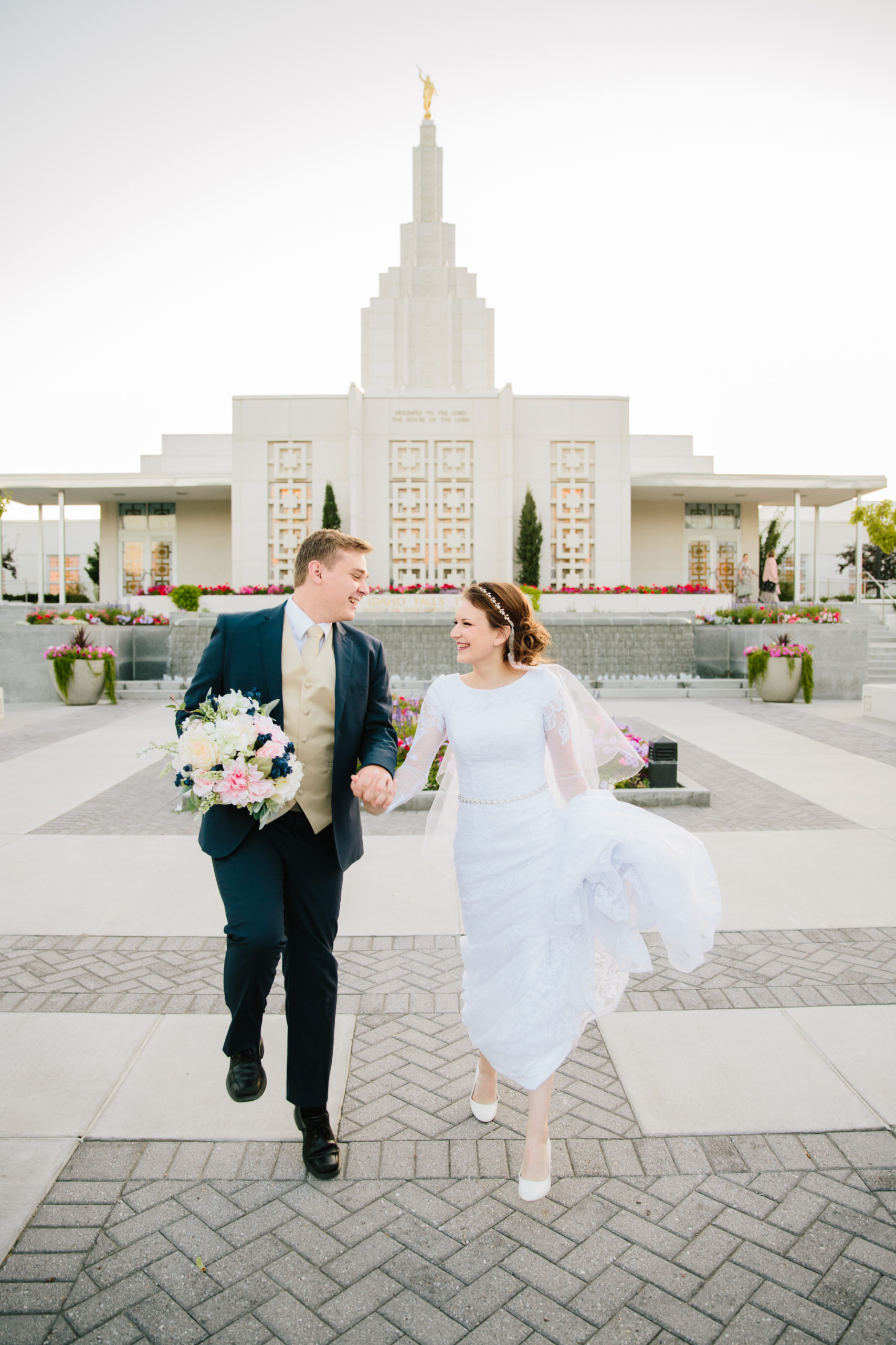 bride and groom skipping away from idaho falls temple wedding Idaho Falls Temple Wedding Tips