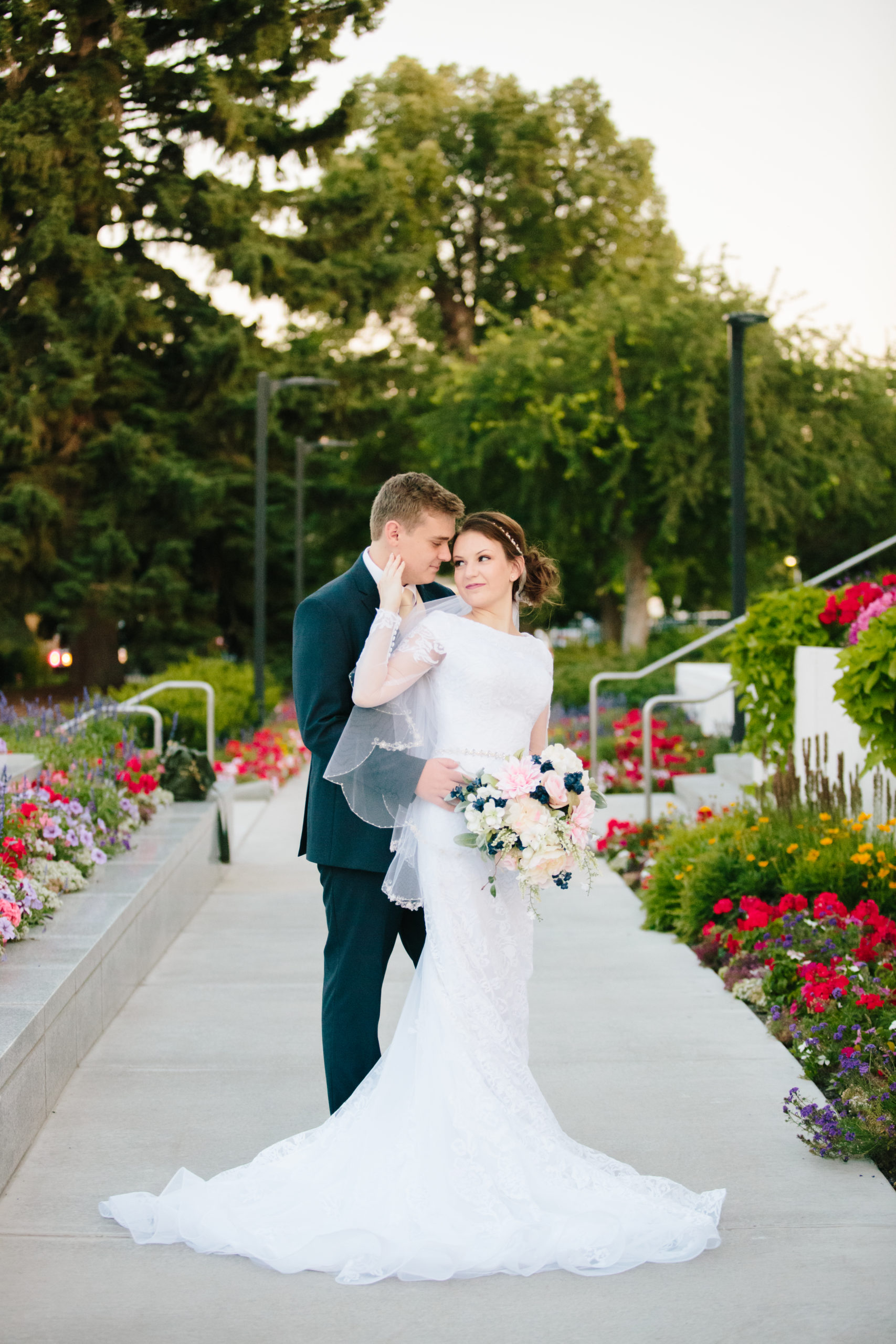 bride and groom standing next to roses in front of the idaho falls temple  Idaho Falls Temple Wedding Tips