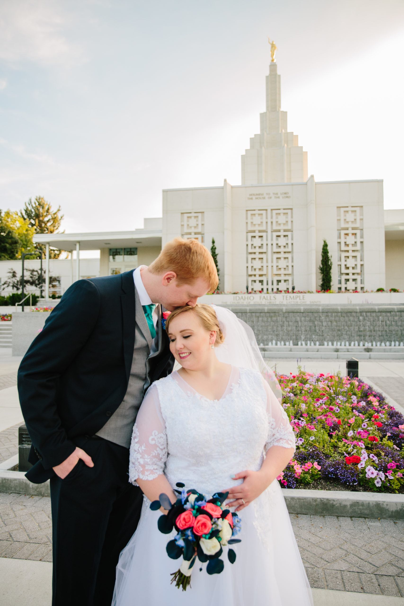 ginger groom kissing brides head at idaho falls temple wedding Idaho Falls Temple Wedding Tips