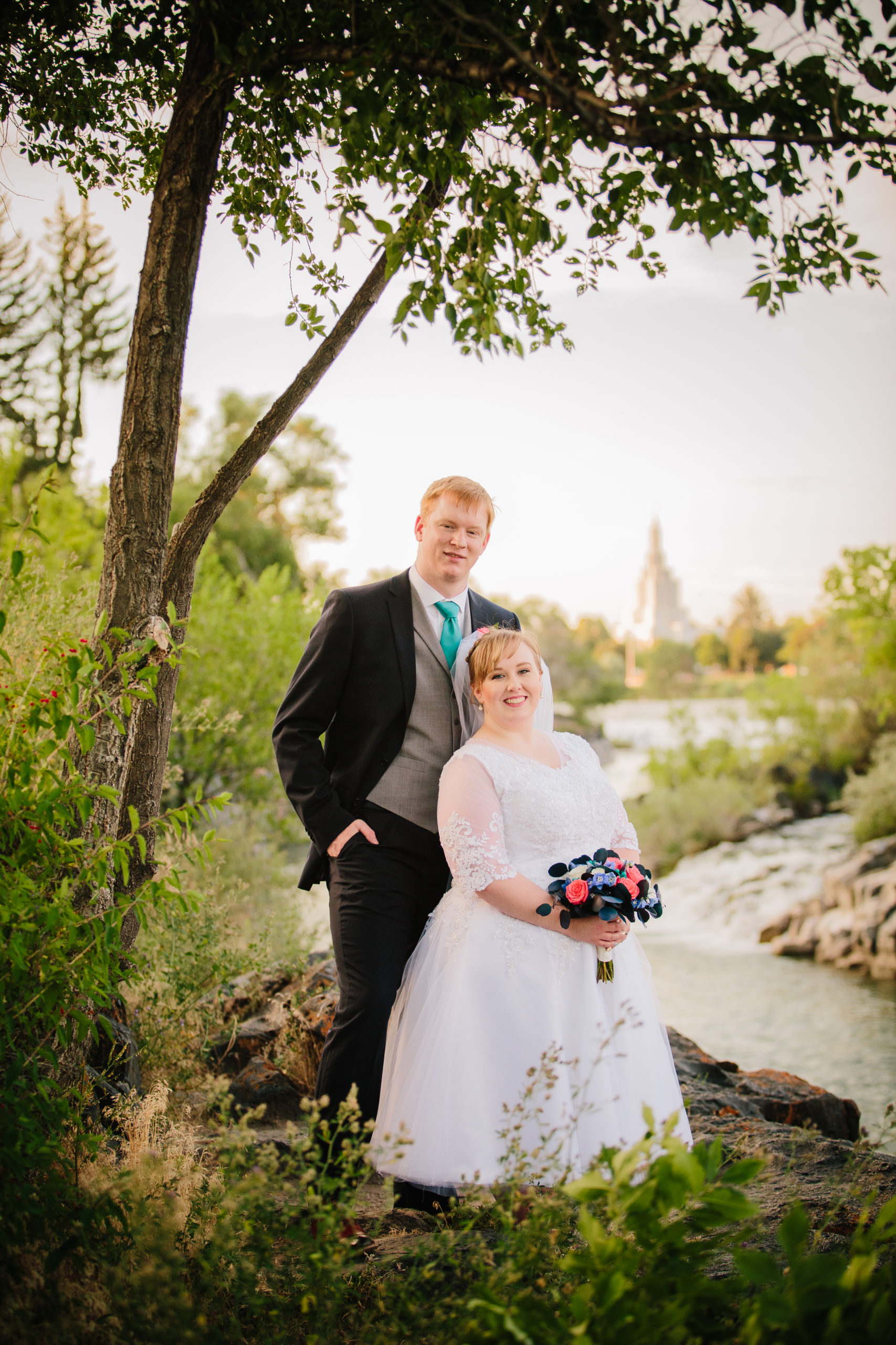 bride and groom standing by the idaho falls falls after their idaho falls temple wedding Idaho Falls Temple Wedding Tips