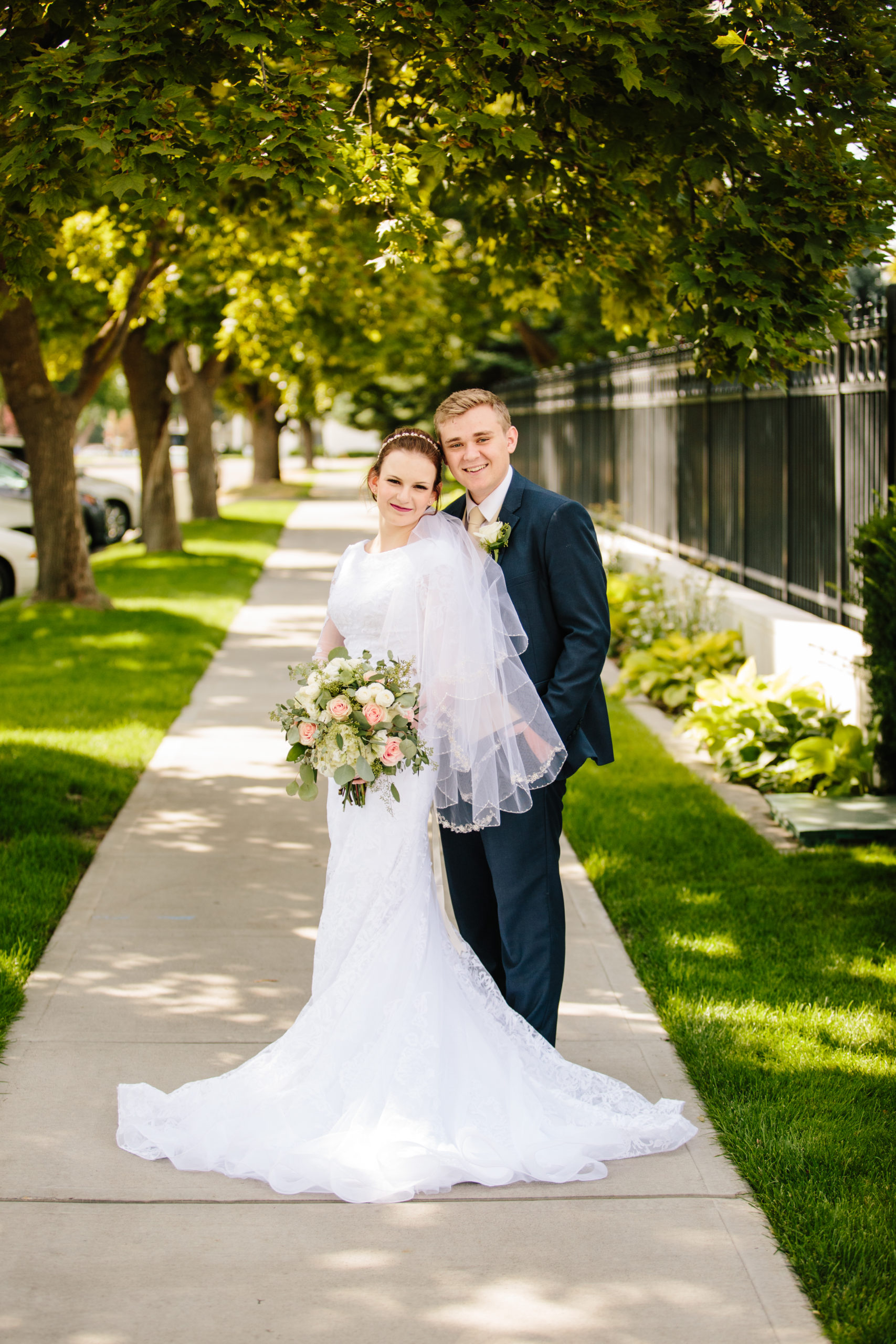 bride and groom standing on sidewalk of idaho falls temple wedding Idaho Falls Temple Wedding Tips