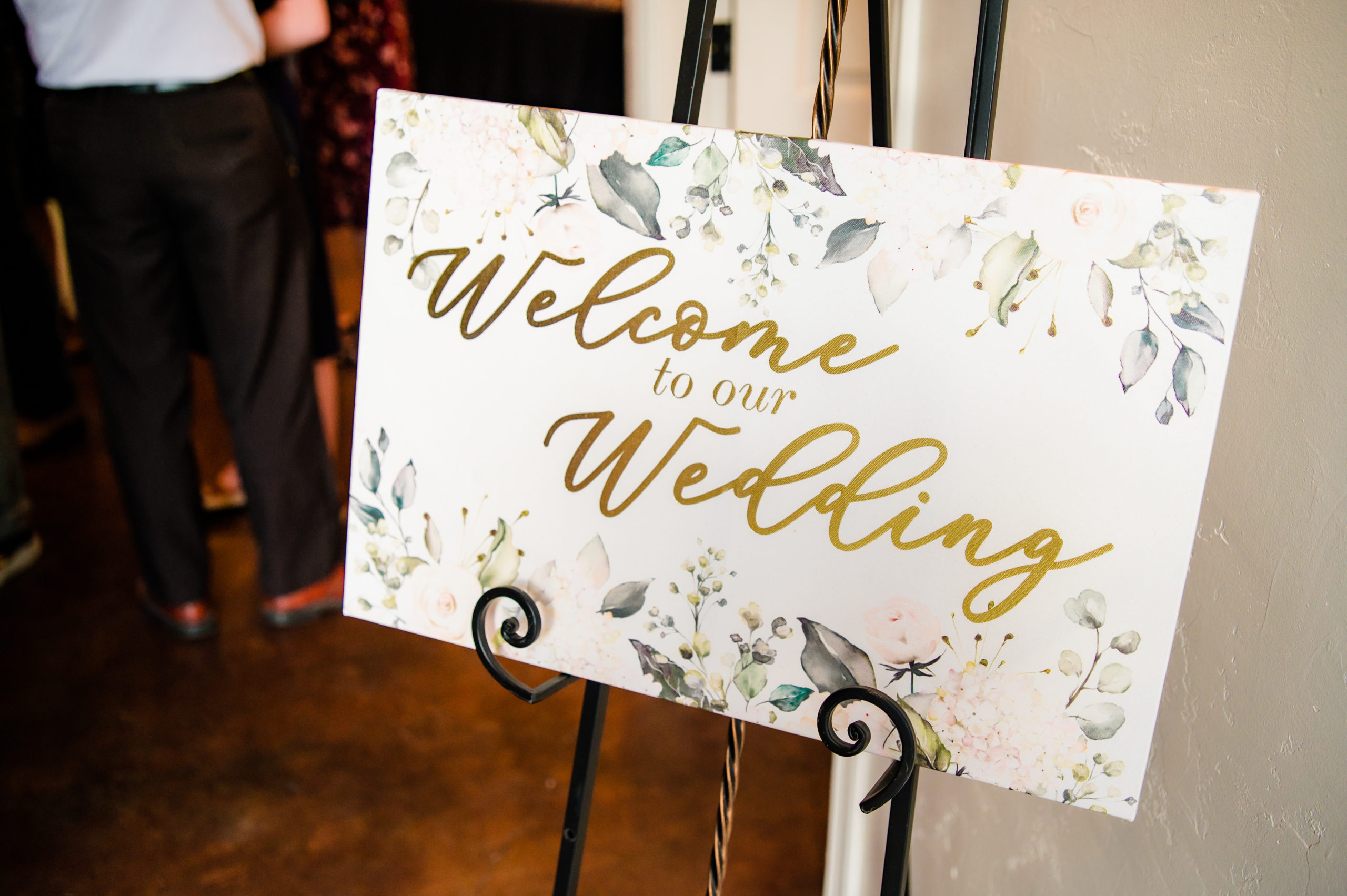 wedding welcome sign with greenery and gold