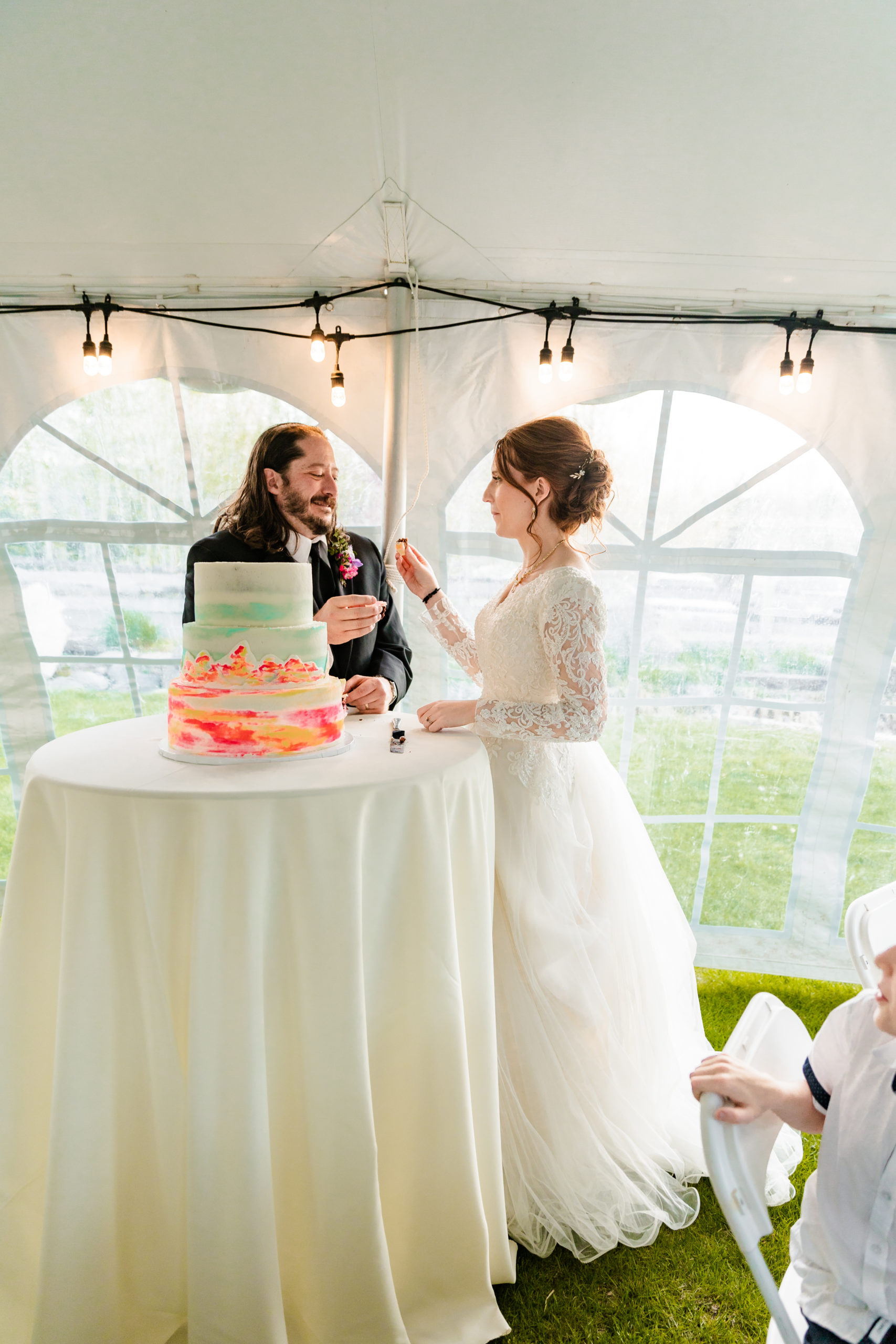 wedding couple feeding cake to one another