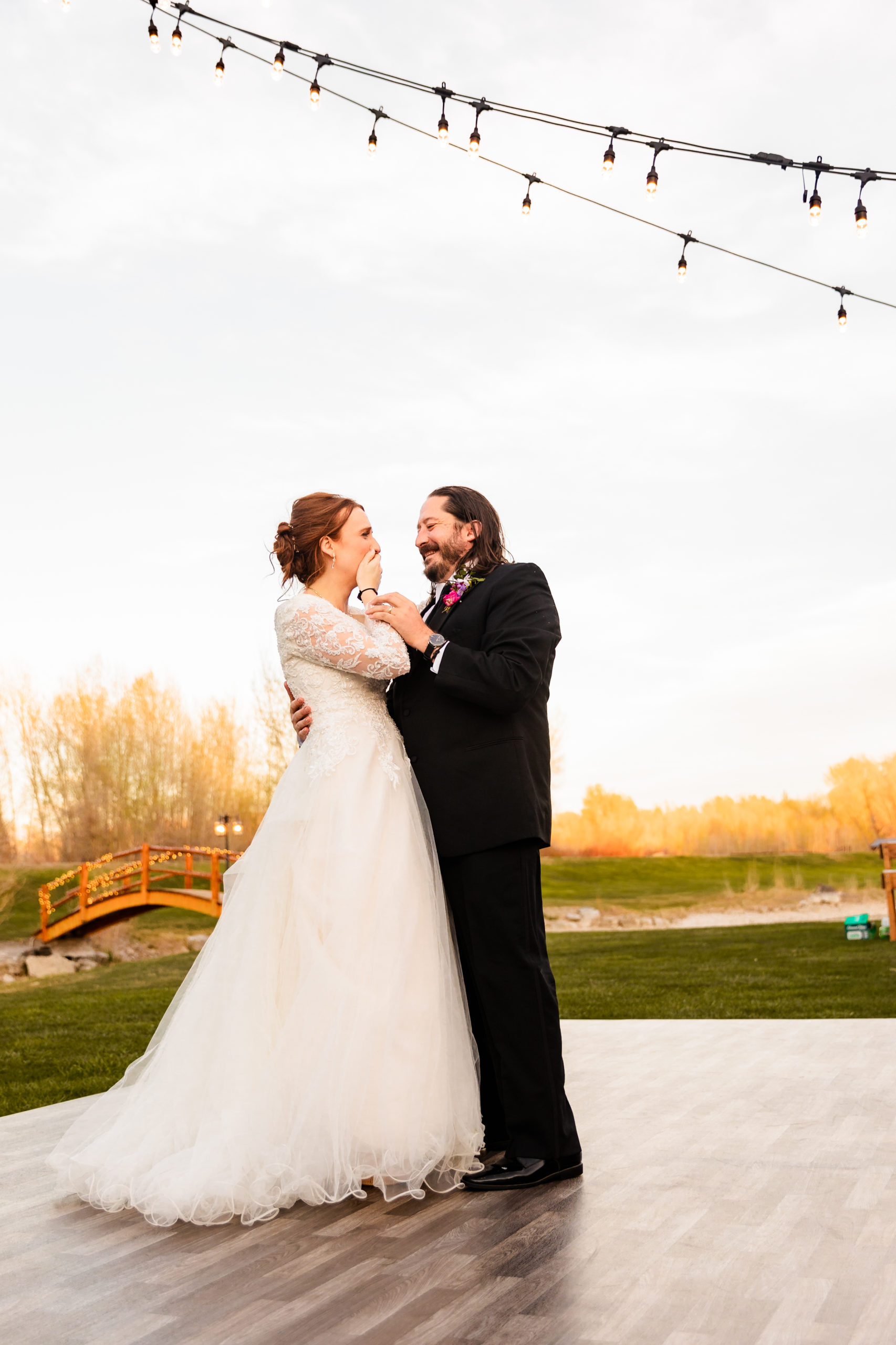 newly married couple laughing and having fun at Colorful LaBelle Lake Reception