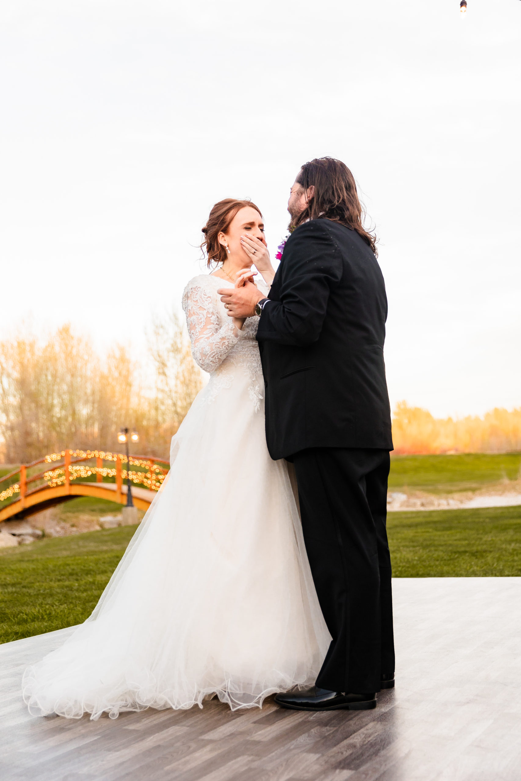 bride crying with groom during first dance at Colorful LaBelle Lake Reception