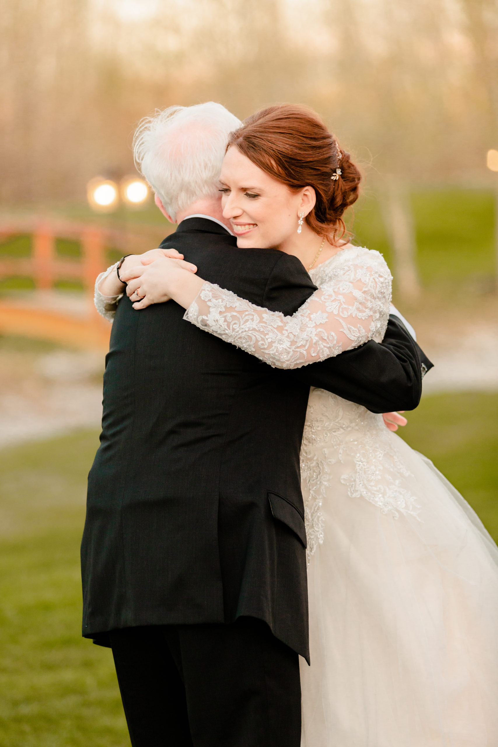 bride hugging father after father daughter dance at Colorful LaBelle Lake Reception