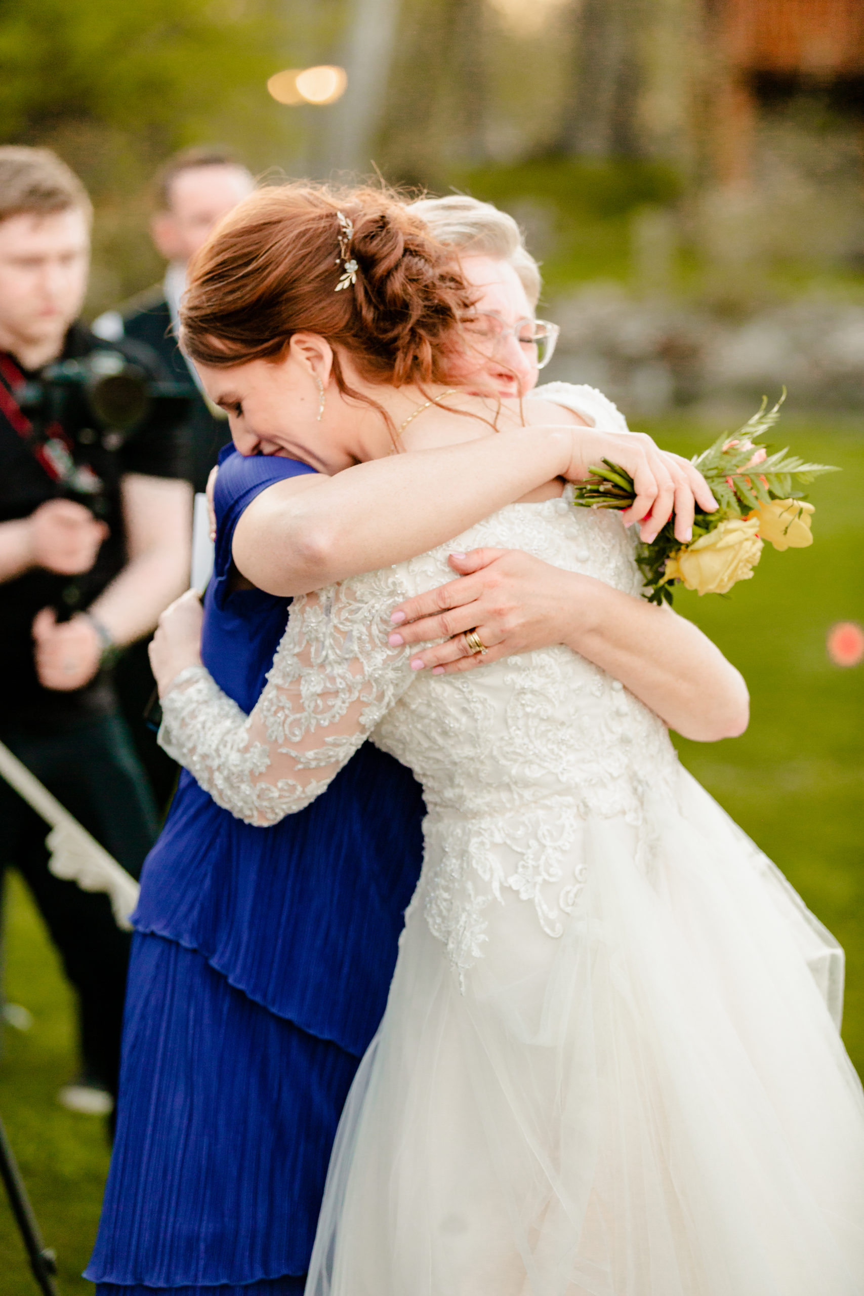 bride hugging mother during colorful labelle lake reception