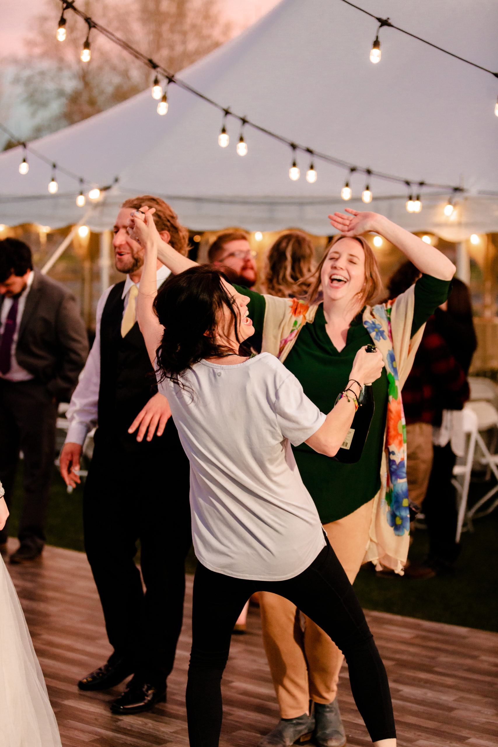 wedding photographer dancing with wedding guests